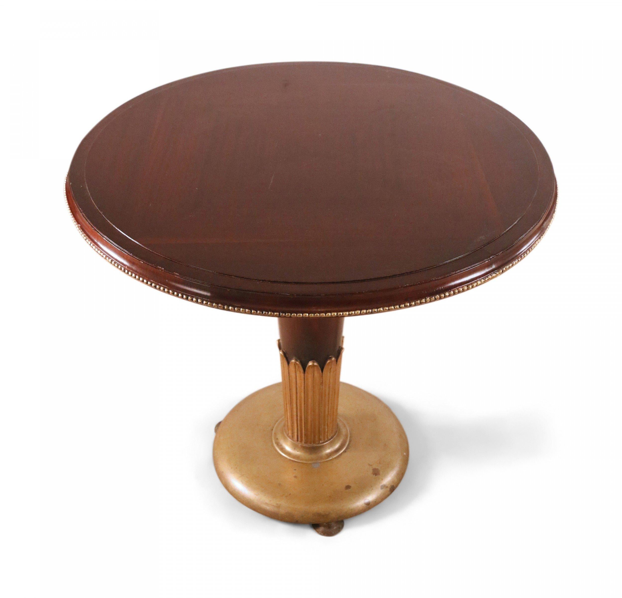 French Art Deco (1920s) circular mahogany end / side table having a stepped circular top with a beaded brass edge on a tapering pedestal column with parcel gilt foliate trim and brass circular base with domed feet.