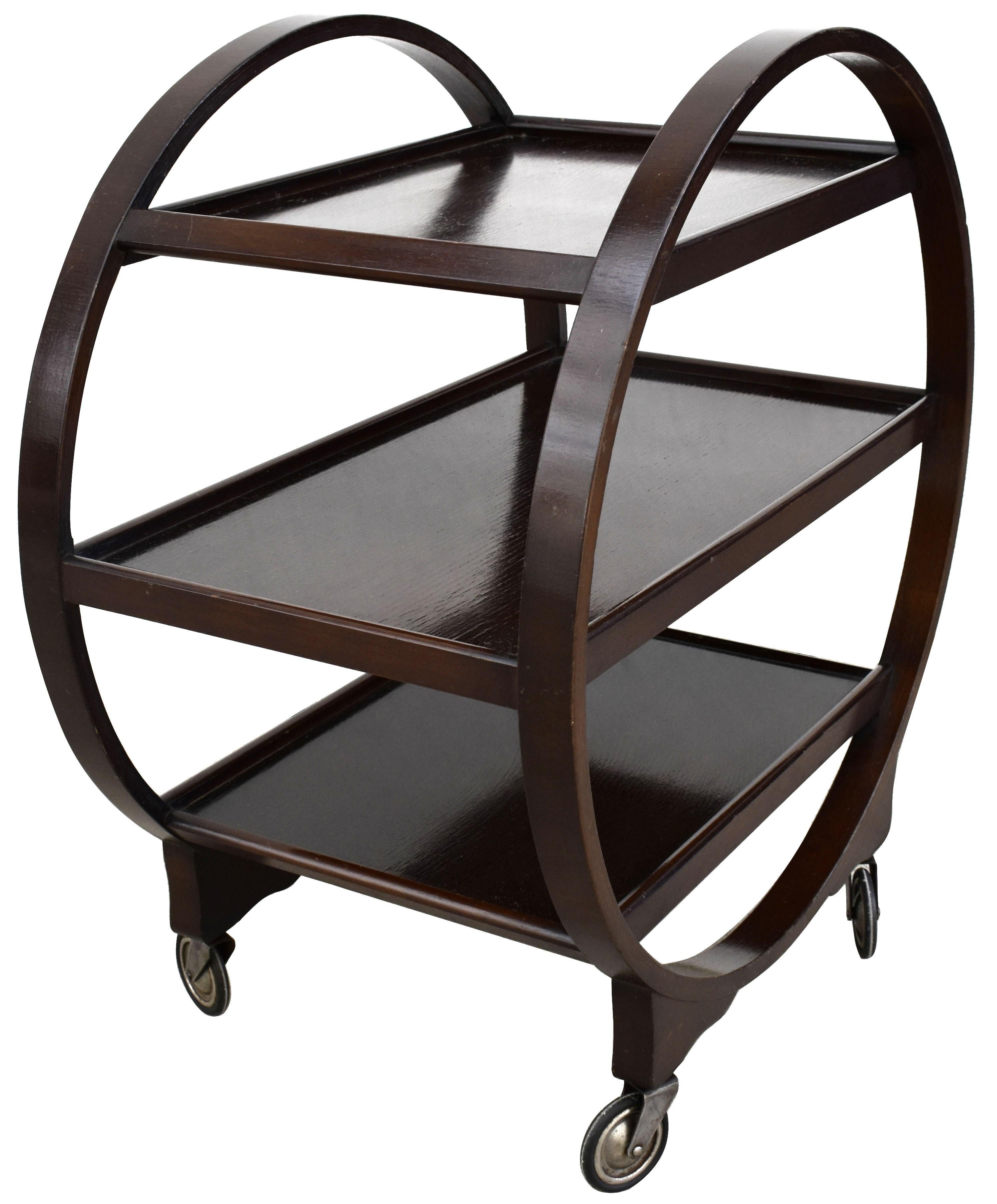 Very attractive and iconic English Art Deco Savoy Hostess trolley cart dating from the 1920s-1930s period. This three-tiered trolley not only looks awesome but is very functional too. Solid walnut in a very dark tone coloring with chrome and rubber