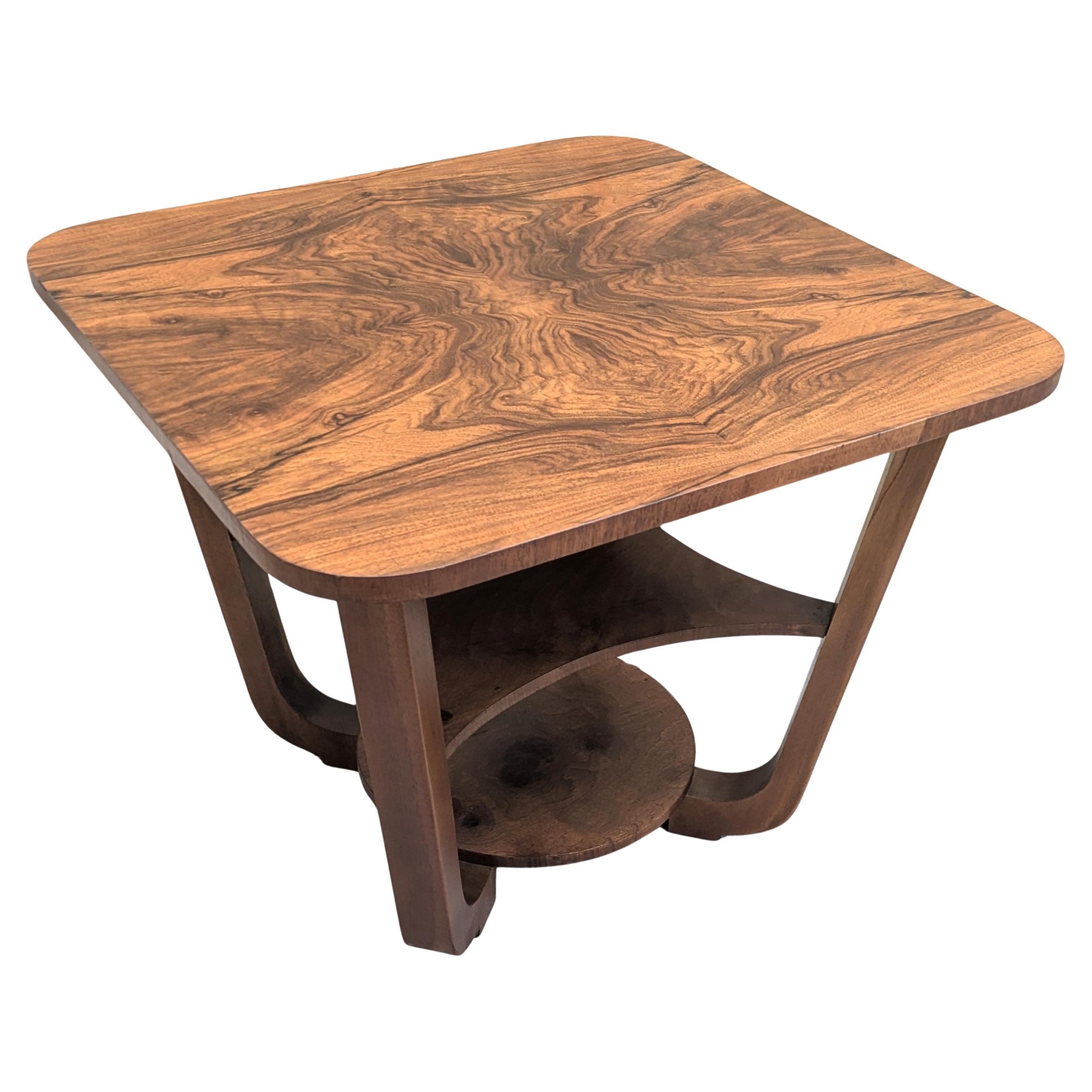 Very Stylish 1930's highly figured walnut Modernist coffee/ side table in superb showroom condition having been recently professionally restored. This is a superb period example which has four curved leg supports which meet to a circular base.