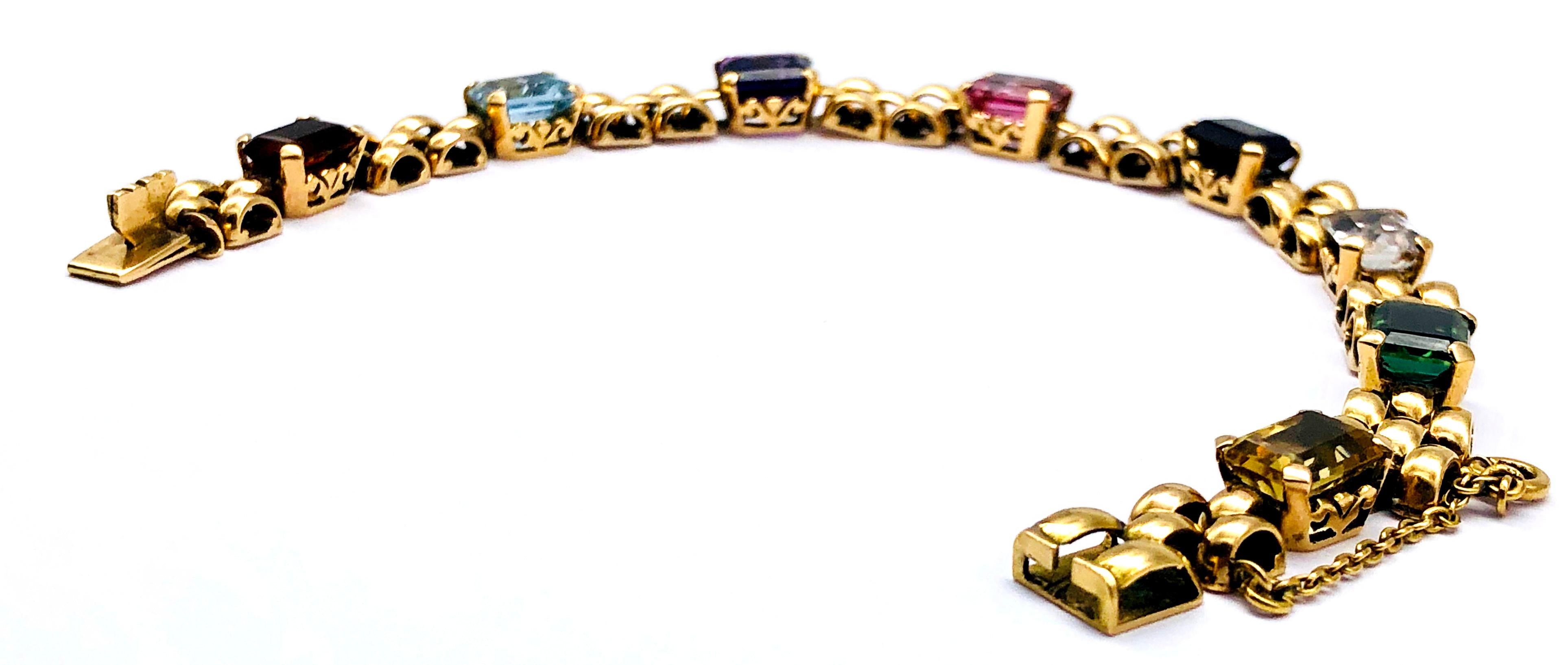 Eight rectangular precious and semi precious stones in vivid colours, cut in step cuts 
make up this unusual fancy Art Deco gate bracelet. The bracelet has been executed in 14 k gold.  

