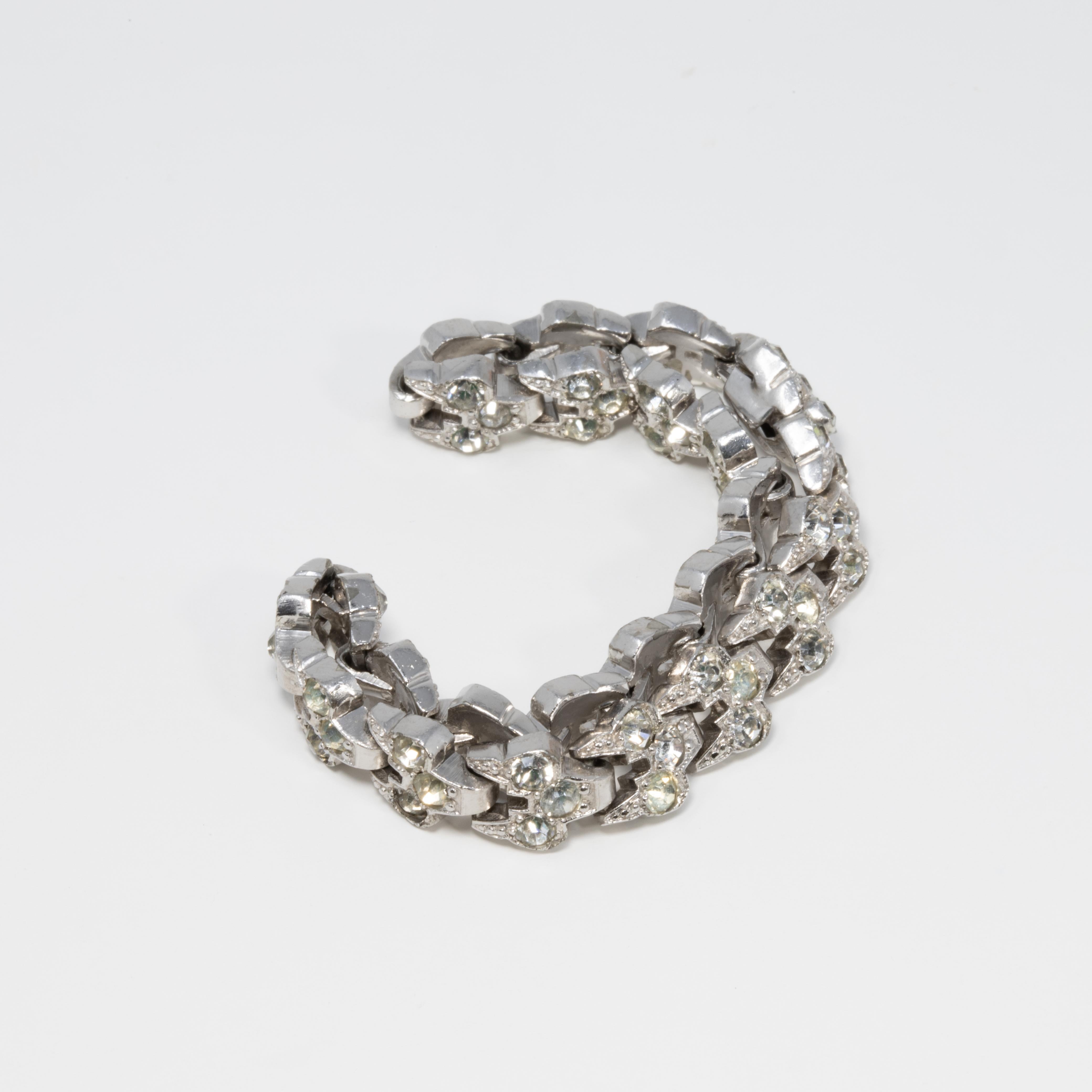 A rhodium-plated link bracelet accented with clear crystals. Fastened with a vintage box clasp mechanism. A brilliant shine!