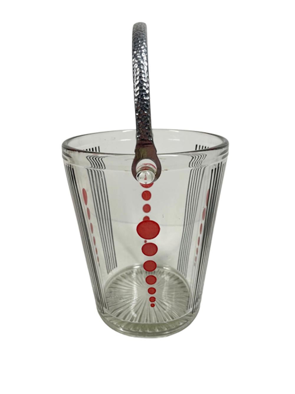 Clear glass ice bucket with chromed hammered metal swing handle decorated with alternating 6 black vertical lines between vertical columns of 6 graduated red dots. The bottom with a pressed starburst foot.