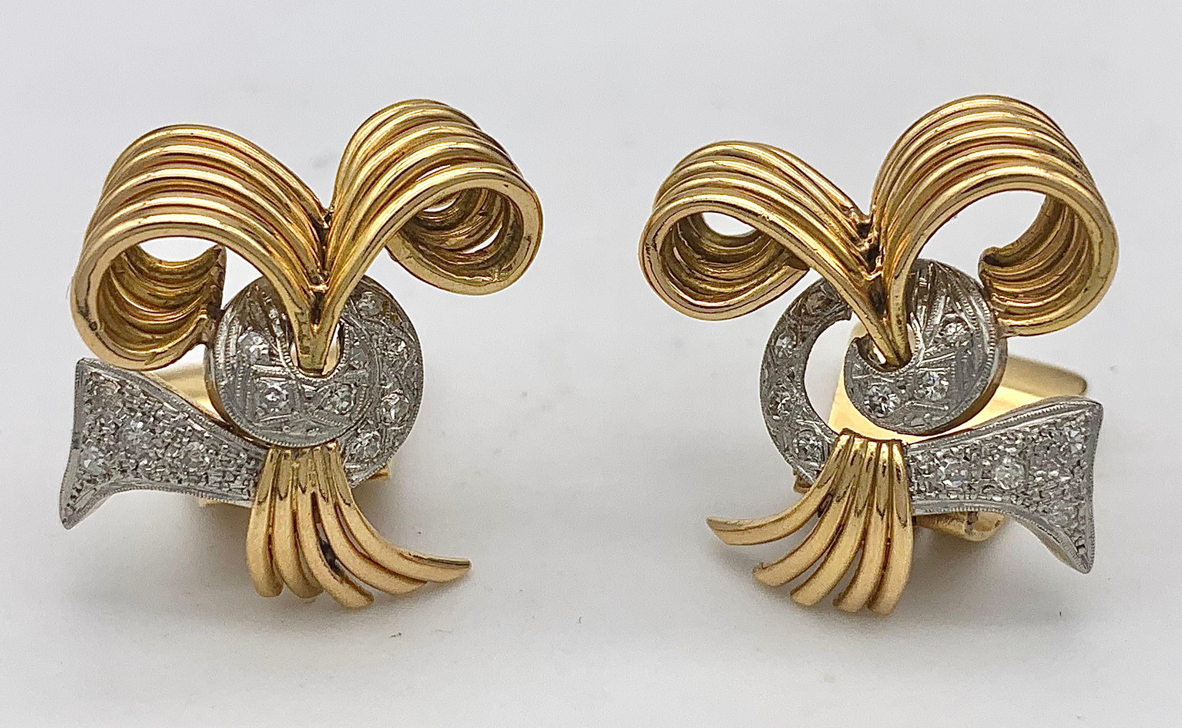 These Art Deco clip-on earrings were made out of 14 karat yellow gold and platinum in the early 1930's. The dynamic design is full of movement. Thick gold wire bundles that curl in all directions are threaded through platinum elements that resemble