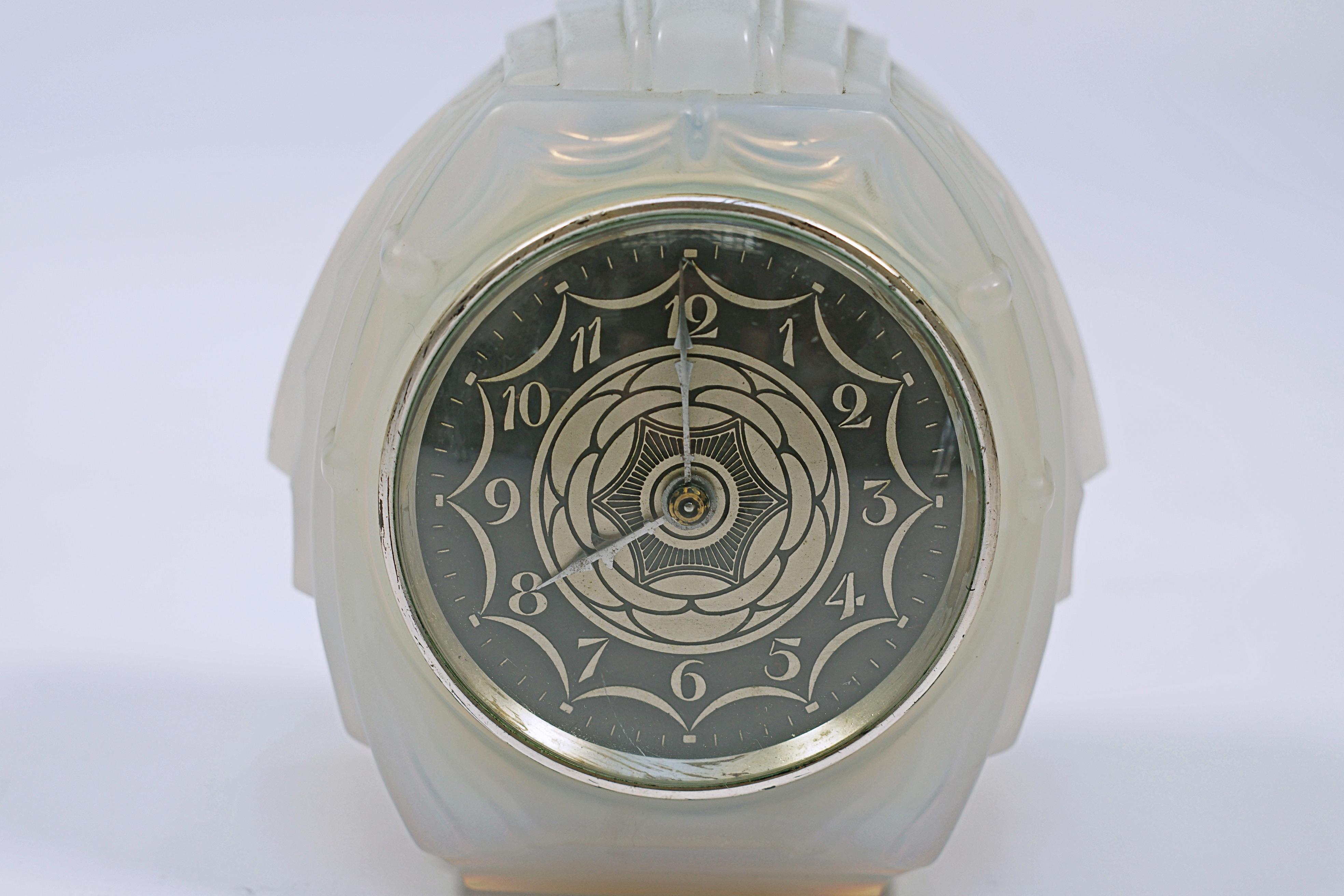 Art Deco clock made of frost glass, with enameled and silver-plated bronze dial, made by Sabino. Signed Sabino, machine EC, France.

France, CIRCA 1920.