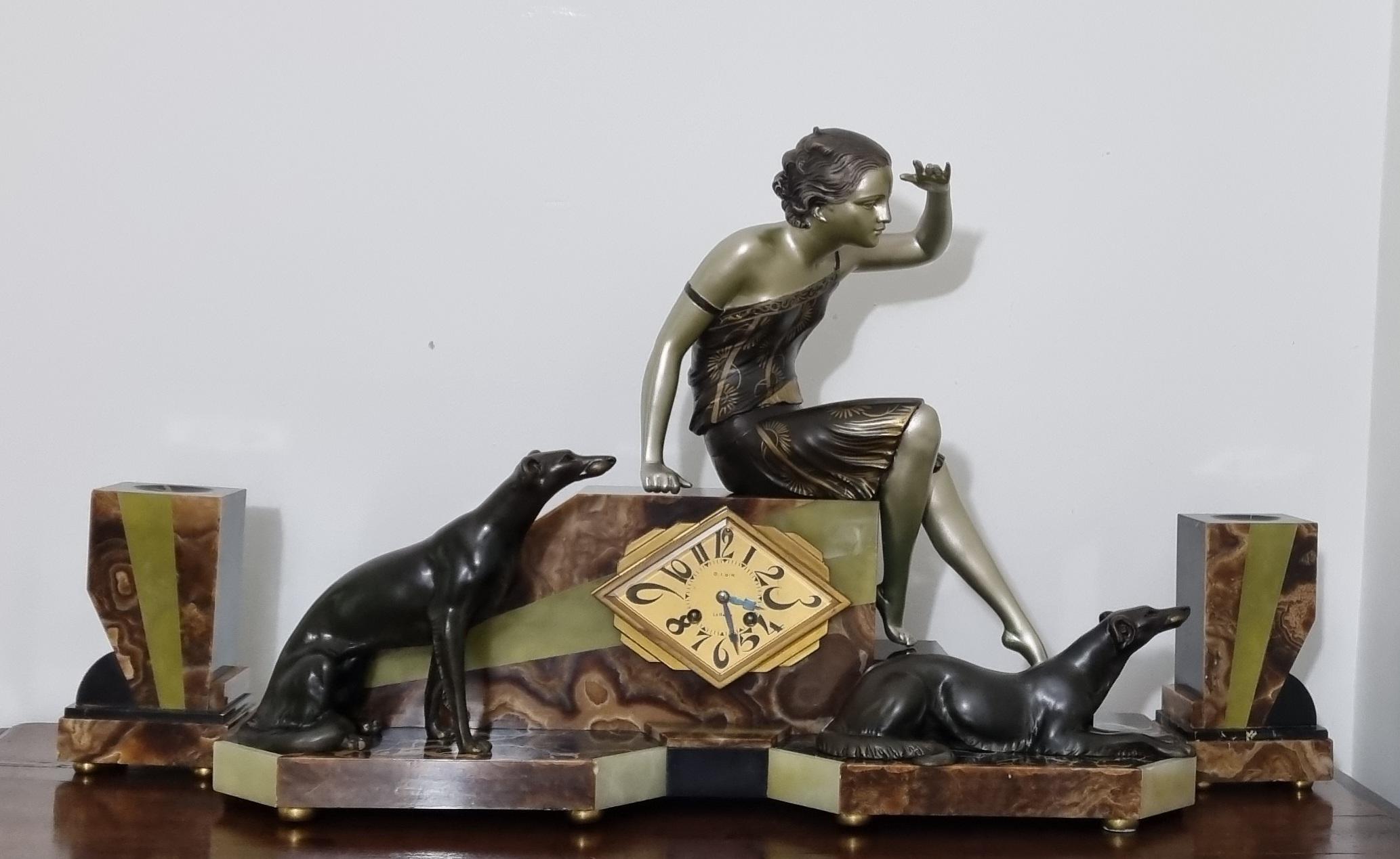 A Spectacular Art Deco Clock Featuring the Sculpture “Waiting” by the Italian Art Deco Artist “Uriano”


Signed on the back of the lady’s dress.

This piece depicts a seated lady on the lookout, accompanied by her two Greyhounds or Borzoi.

The