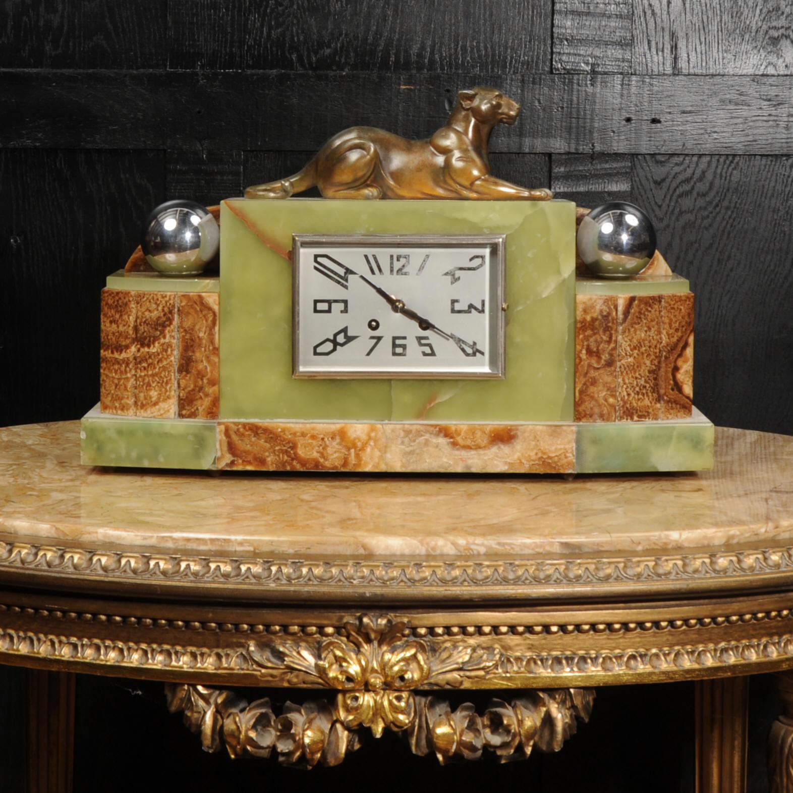 A beautiful original French Art Deco clock, circa 1925. It features a beautifully captured figure of a lioness, although unsigned, it is in the cubist manner of Michel Decoux (1837-1924). The case is geometrically formed of stunning specimen green,