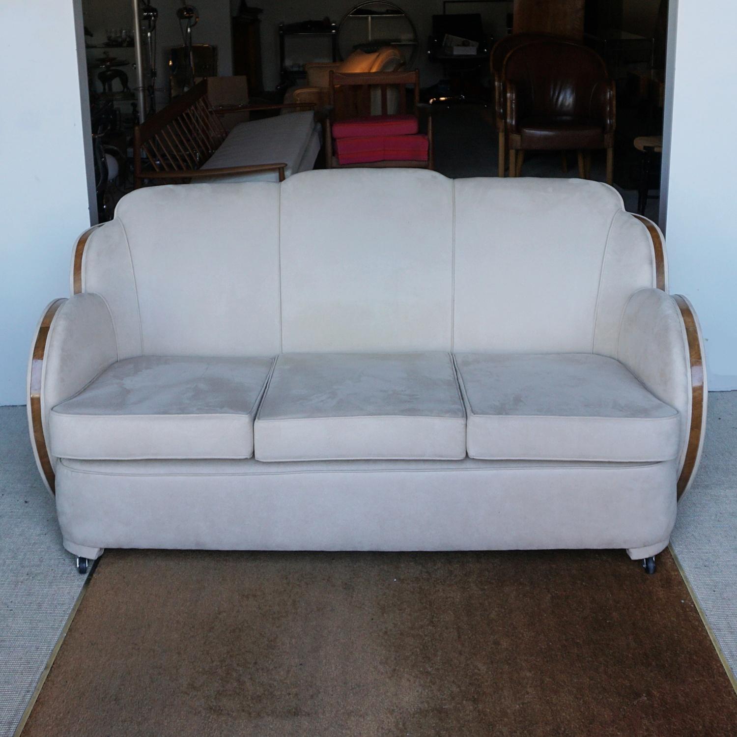 An Art Deco three seat cloud back sofa by Harry and Lou Epstein. Figured walnut banding, re-upholstered in Alcantara suede. Replacement castors.

Dimensions: H 85cm, W 170cm, D 85cm, Seat H 45cm, Seat D 60cm

Origin: English

Date: