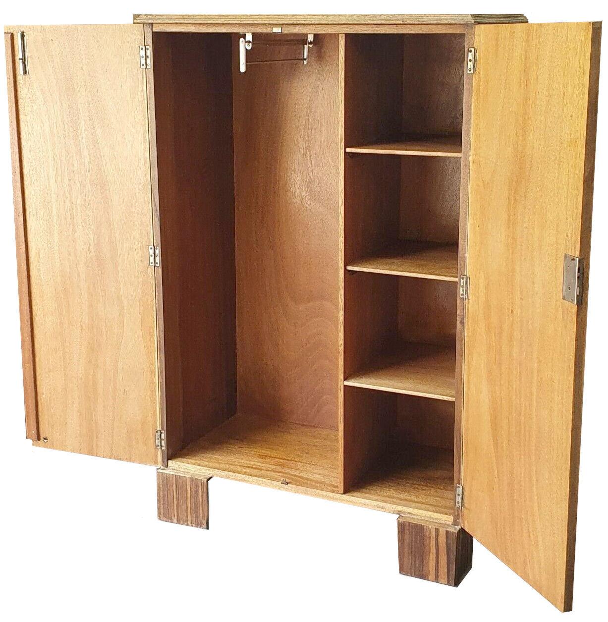 For your consideration is this fabulously styled Art Deco wardrobe dating to the 1930's. Small and well proportioned this wardrobe has stunning Walnut grain with book paged veneers which has been cut to give a cloud effect to the doors. The edges