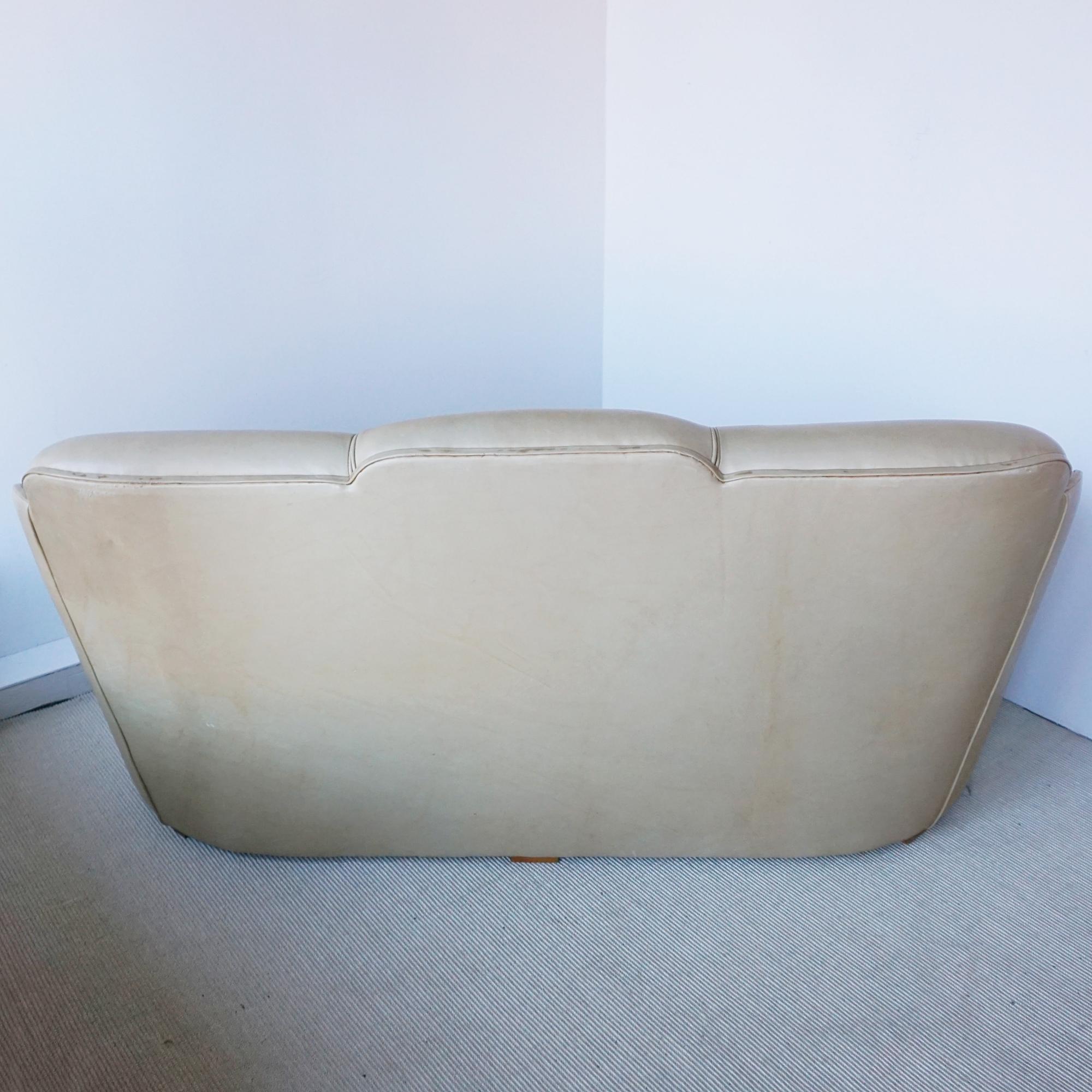 An Art Deco 'Cloud' Sofa by Harry & Lou Epstein. Three seater cloud back sofa with figured walnut show wood banding. Vintage leather upholstery. 
