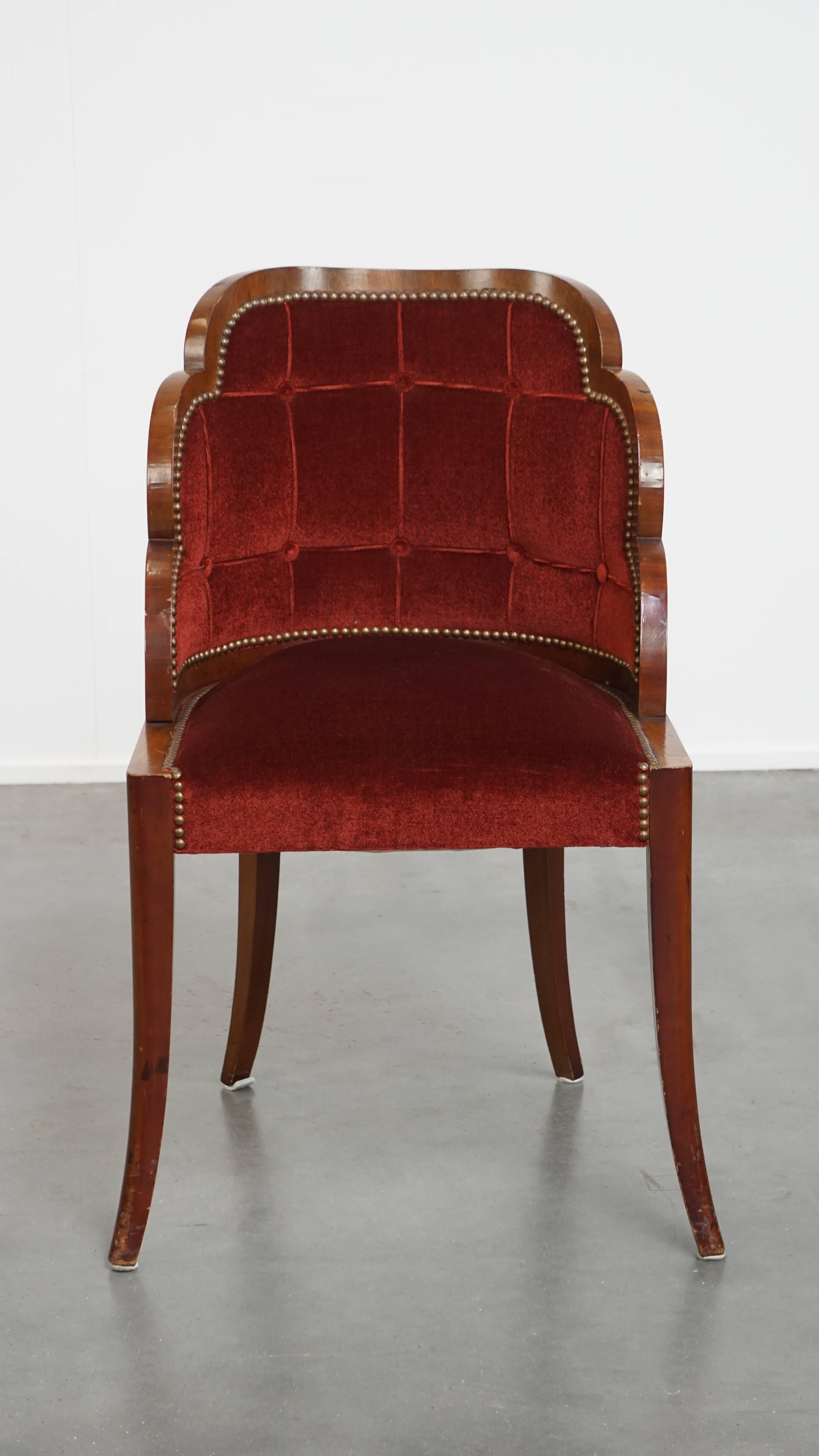 Offered this very charming Art Deco “clouds” dining room/side chair with luxurious red upholstery.

This special Art Deco dining room chair is different, unique and recognizable by its rounded shapes and beautiful use of materials. The chair is