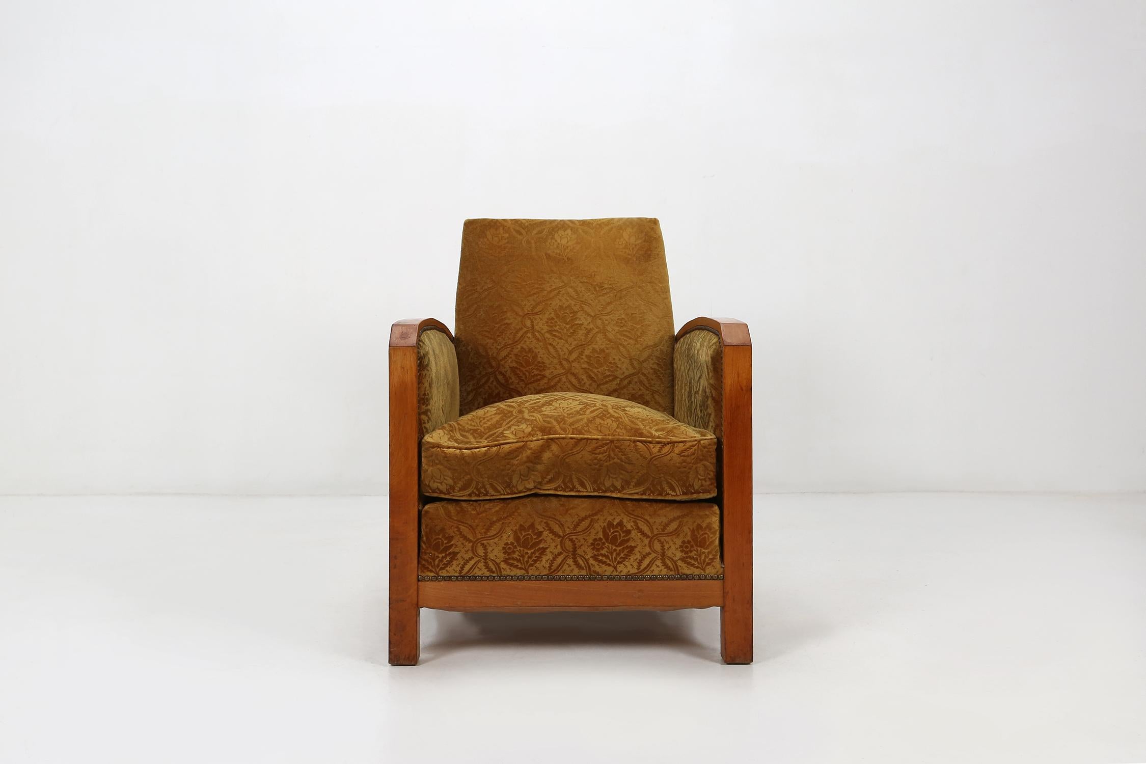 Comfortable Art Deco club chair in yellow velvet fabric.