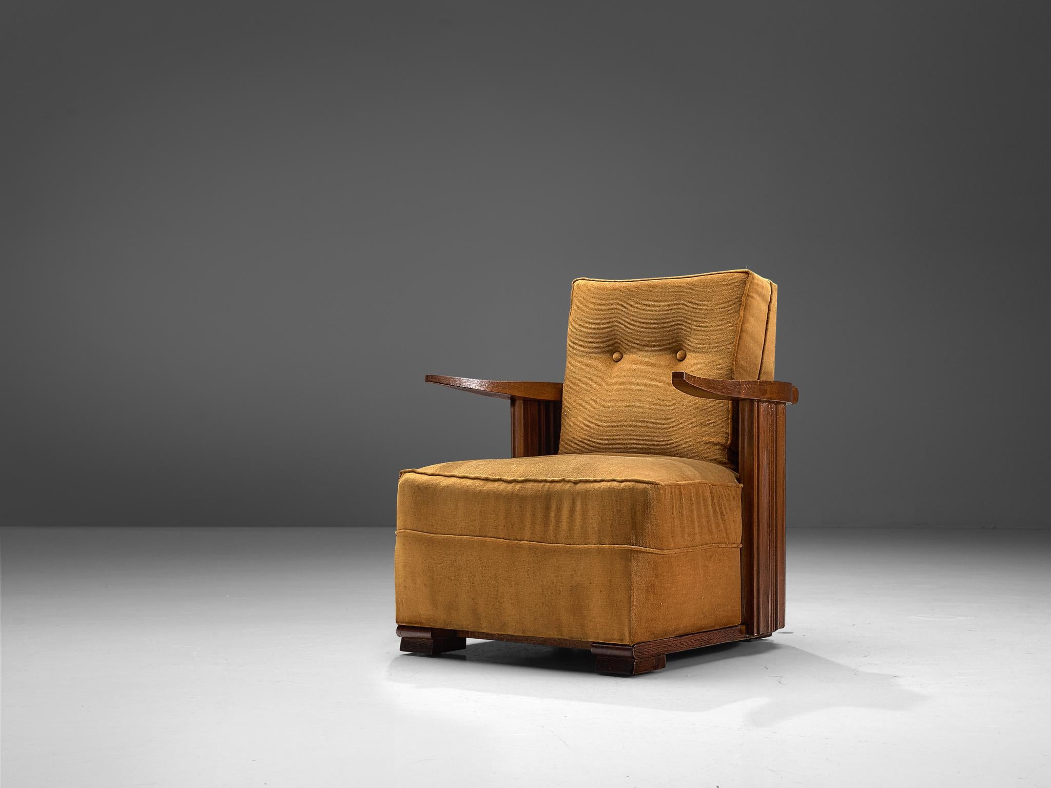 Lounge chair, oak and ocre velvet, France, 1930s

This unique design features cow horn-shaped armrests, thick cushions and carved, closed, striped sides. The legs consists of two horizontal, flat oak carved pieces of oak. Providing this set with a