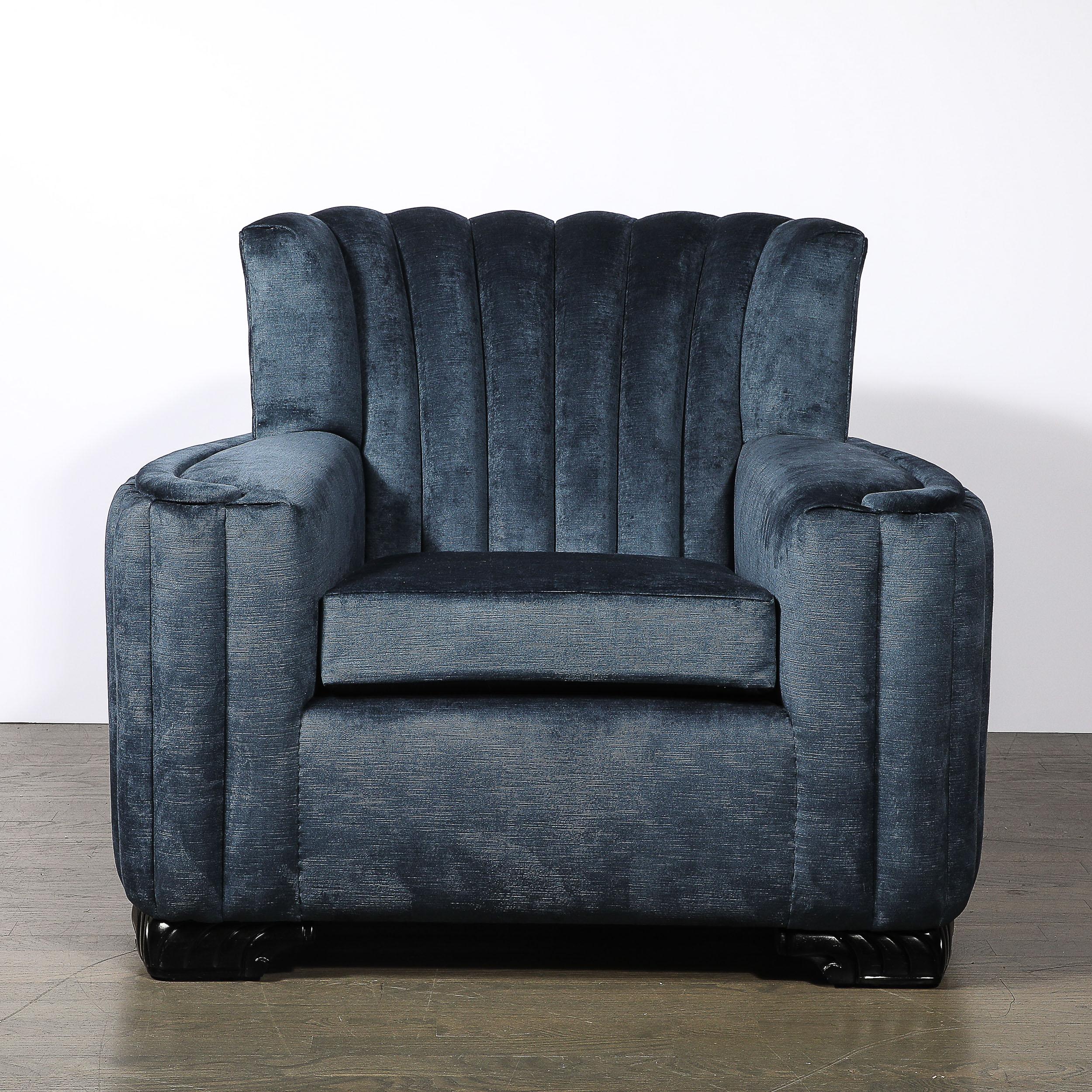 Questa splendida poltrona da club Art Déco, realizzata in America intorno al 1930, è la quintessenza del design dell'epoca, con i suoi straordinari supporti scultorei in legno ebanizzato che la incorniciano con precisione architettonica. L'audace