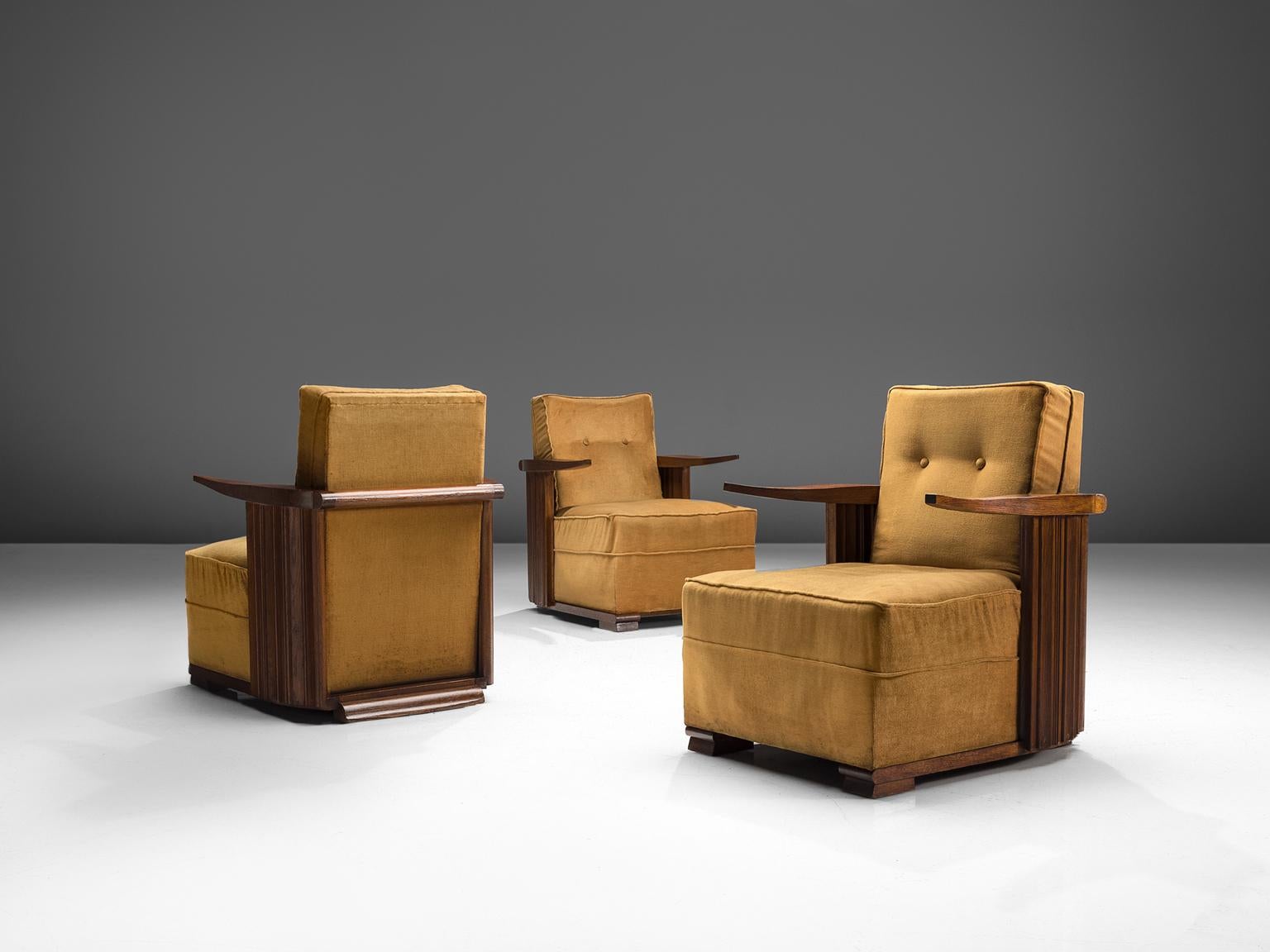 Lounge chairs, oak and ocre velvet, France, 1930s

This unique design features cow horn-shaped armrests, thick cushions and carved, closed, striped sides. The legs consists of two horizontal, flat oak carved pieces of oak. Providing this set with