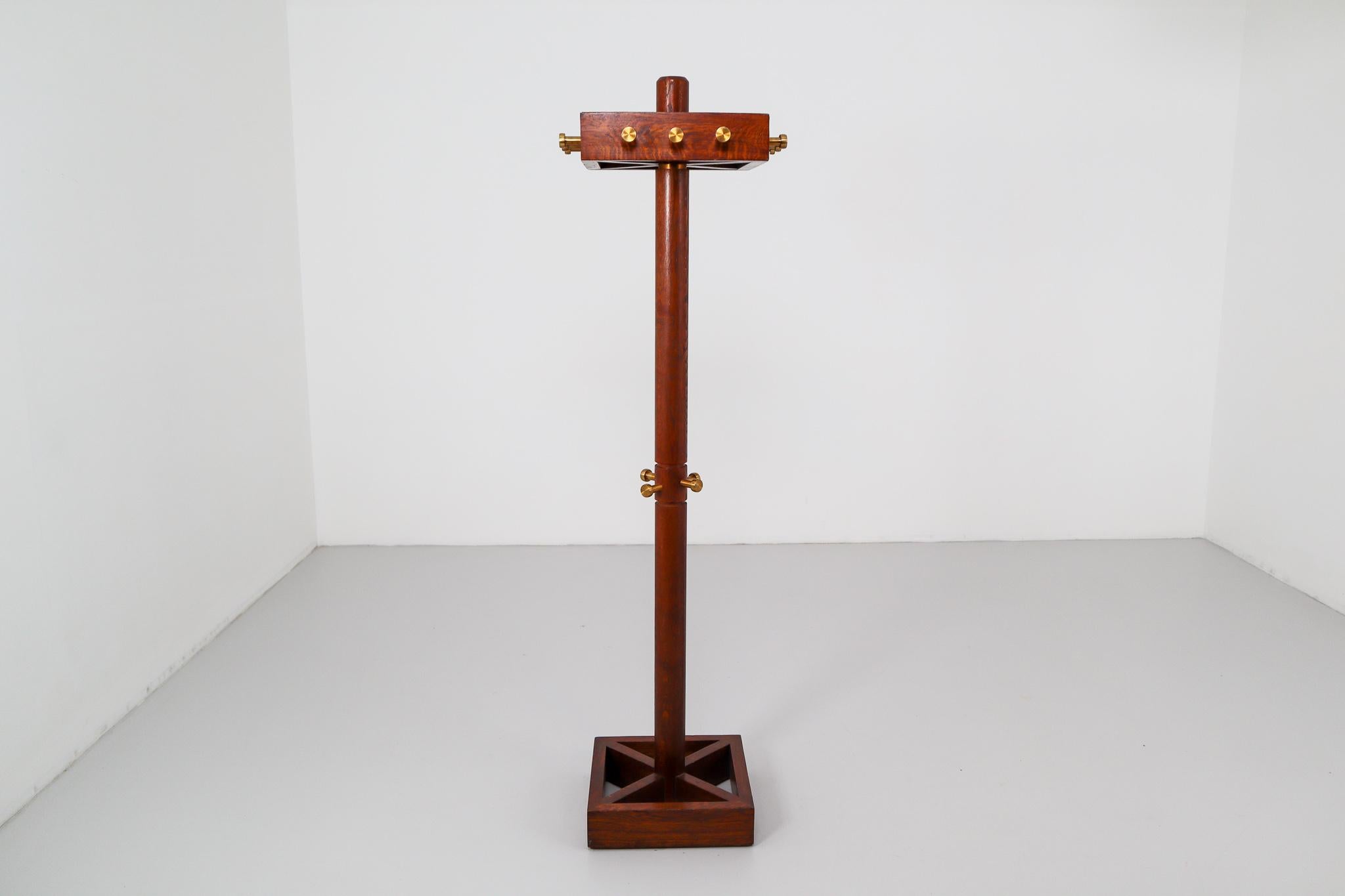 These Art Deco coat hangers are made from solid oak with brass details. This coat stand retains its original finish. A stylish addition to a modern interior, this coat hanger boasts a plush allure in its simple silhouette.

Please note the price