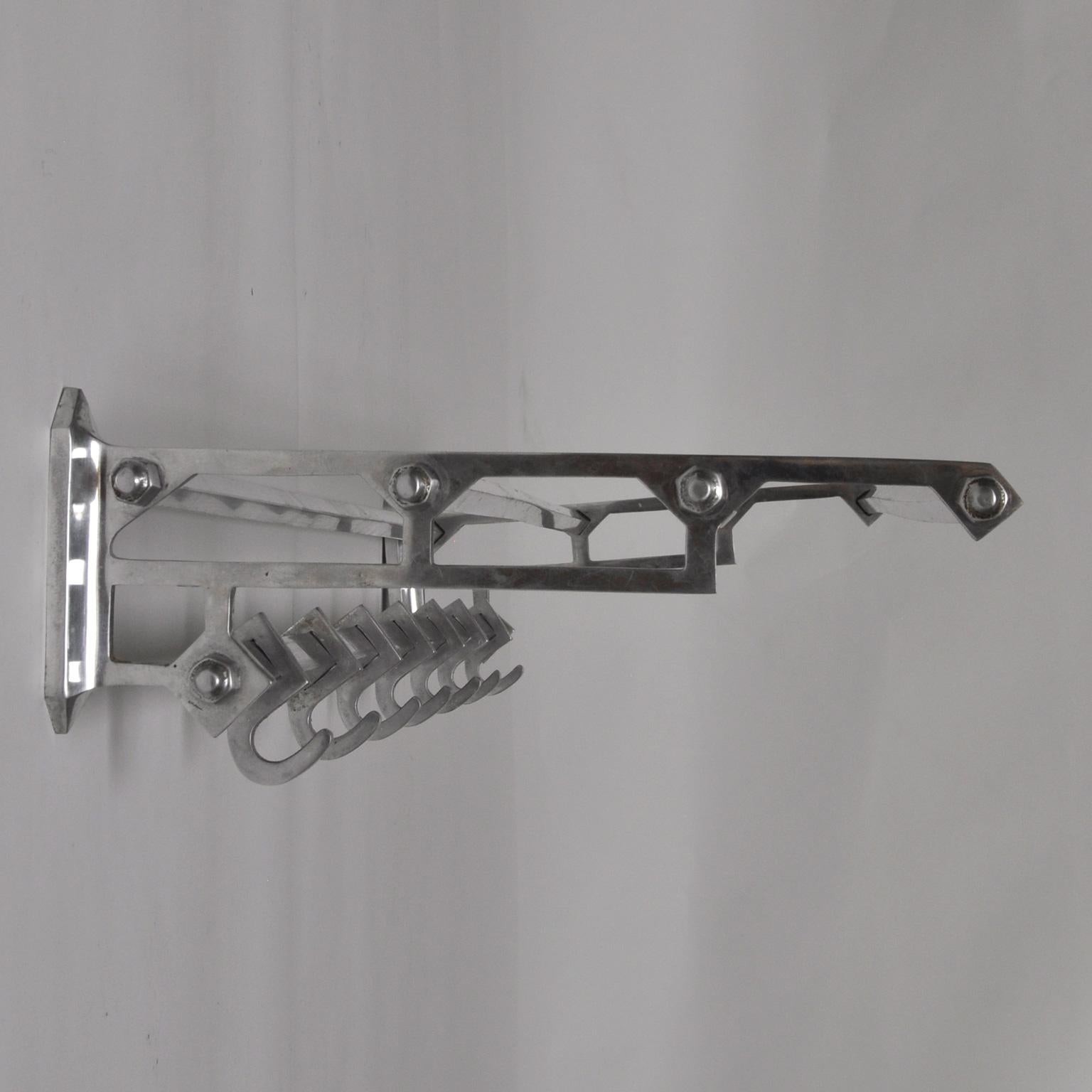 Coat rack in art deco style. Produced from aluminum and iron in the 1950s.