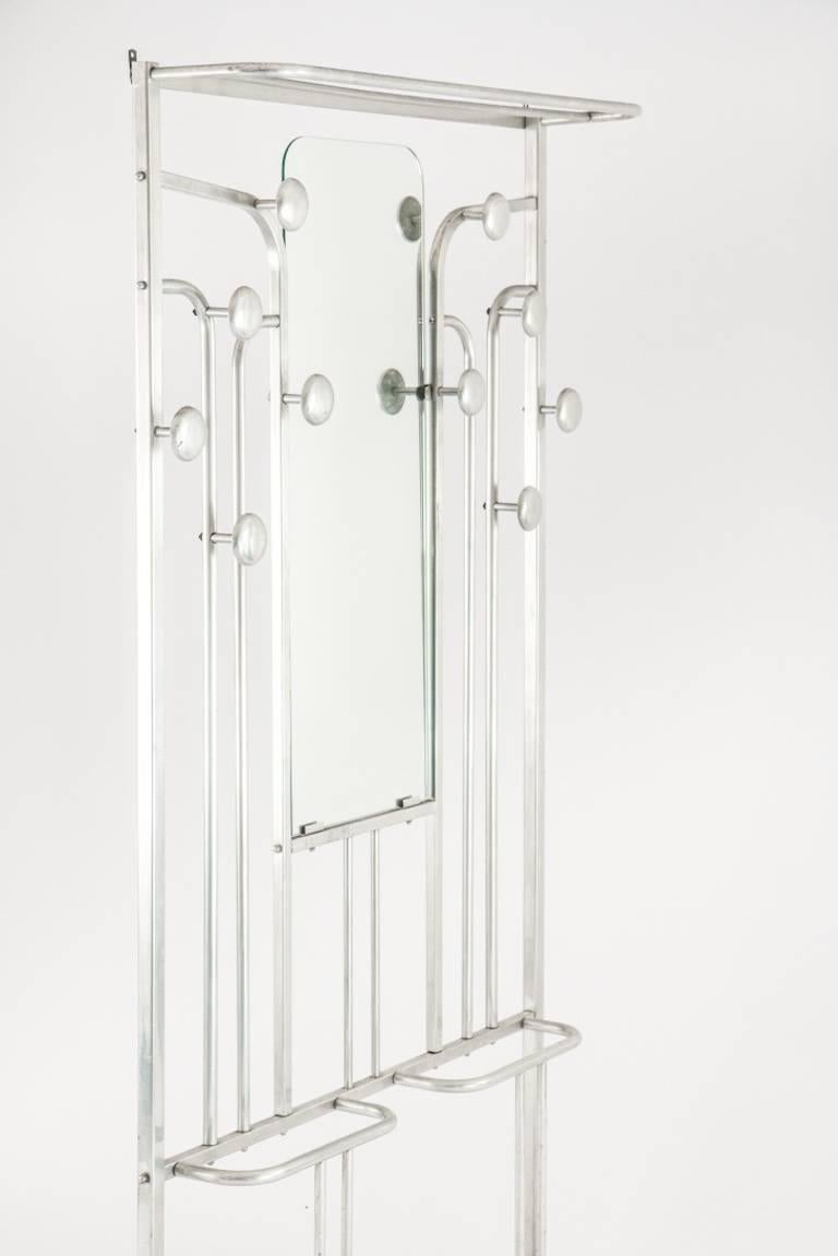 An original Art Deco coat rack or umbrella stand from France of the 1940s, aluminium steel with original mirror.