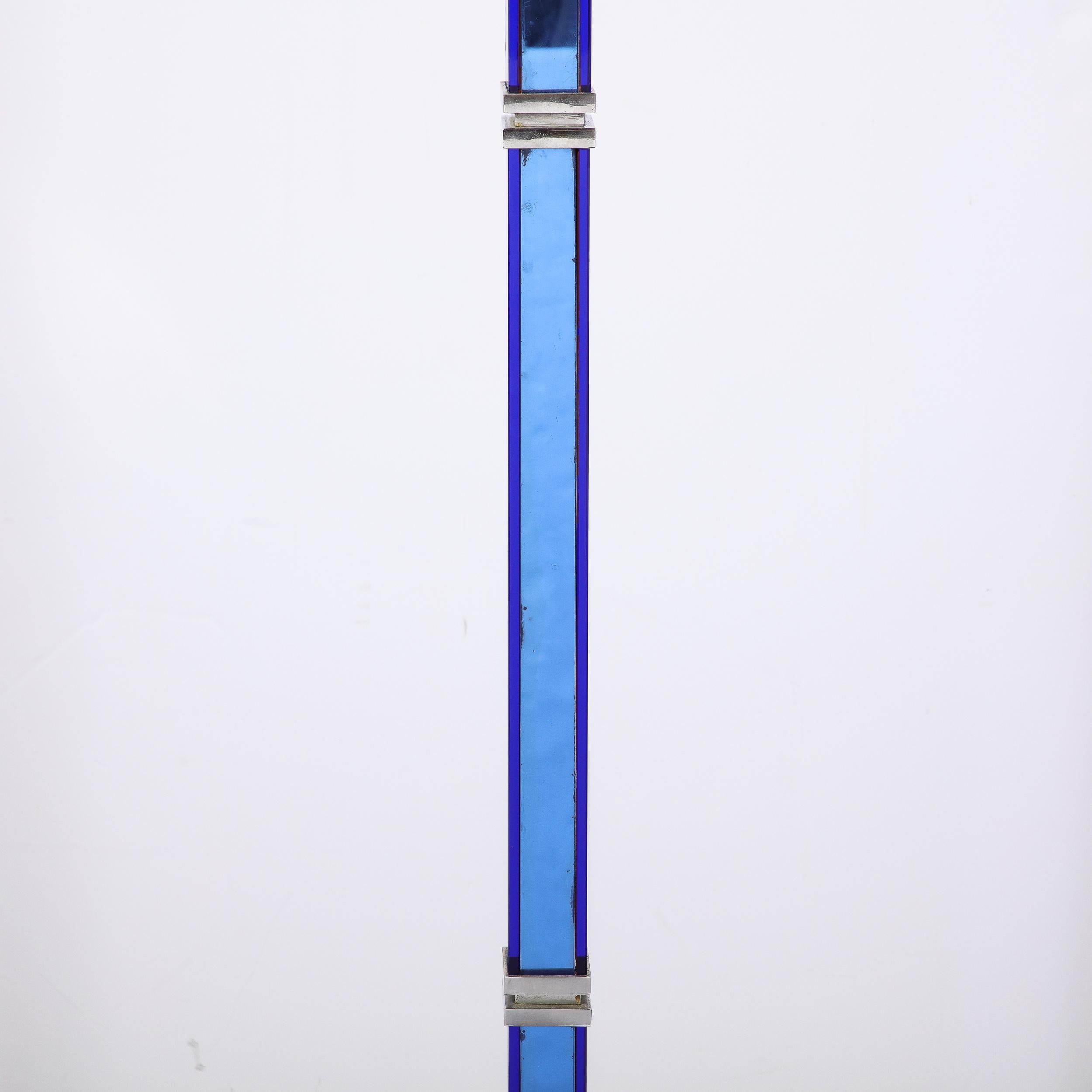 This Art Deco blue and Milk Glass Torchiere, originating from the United States Circa 1935 is an excellent example of the Machine Ages influence on Art Deco in America. This artful cobalt blue glass and satin nickel torchiere incorporates classic