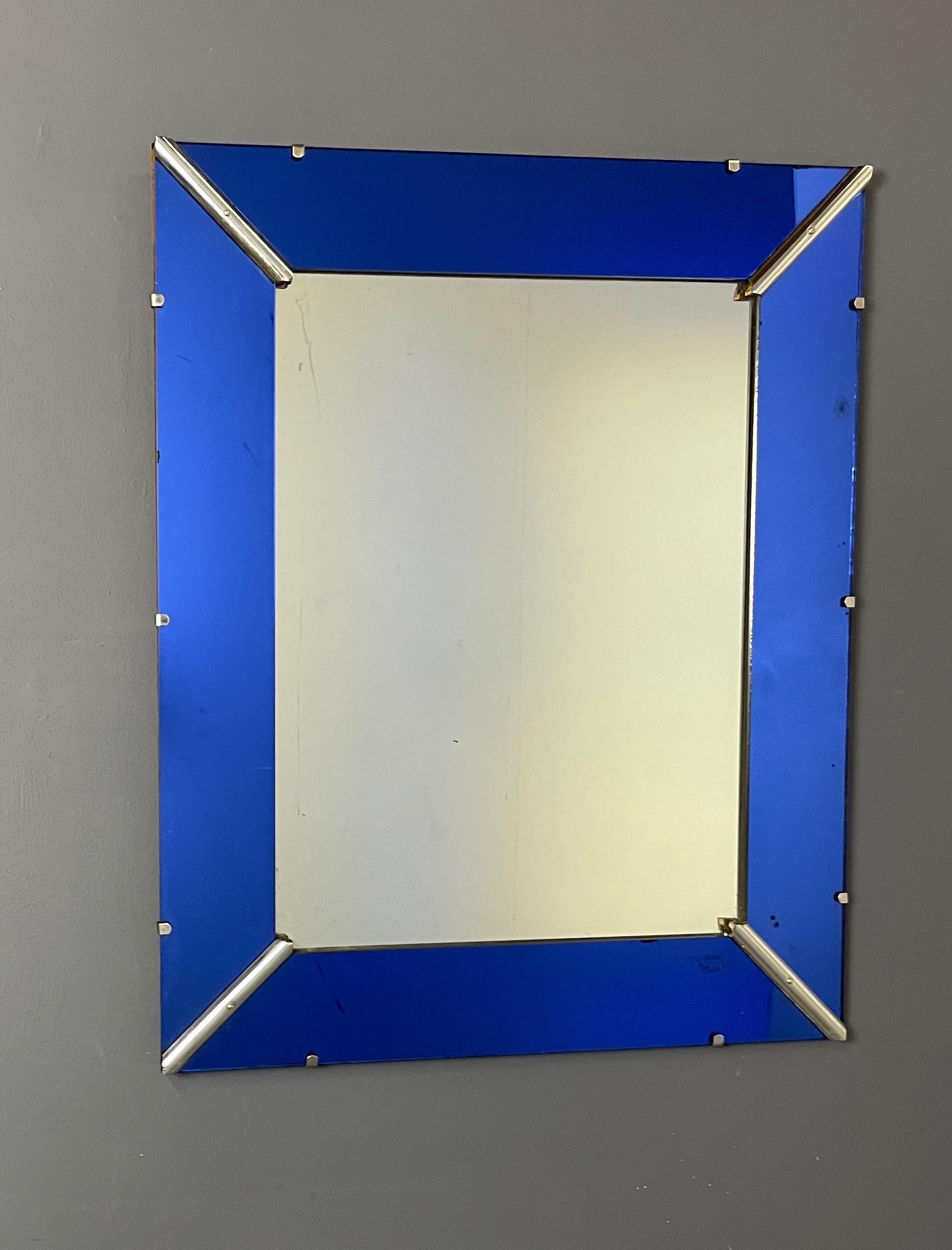 Miroir Art Déco garni de bleu cobalt avec montures d'angle en aluminium.