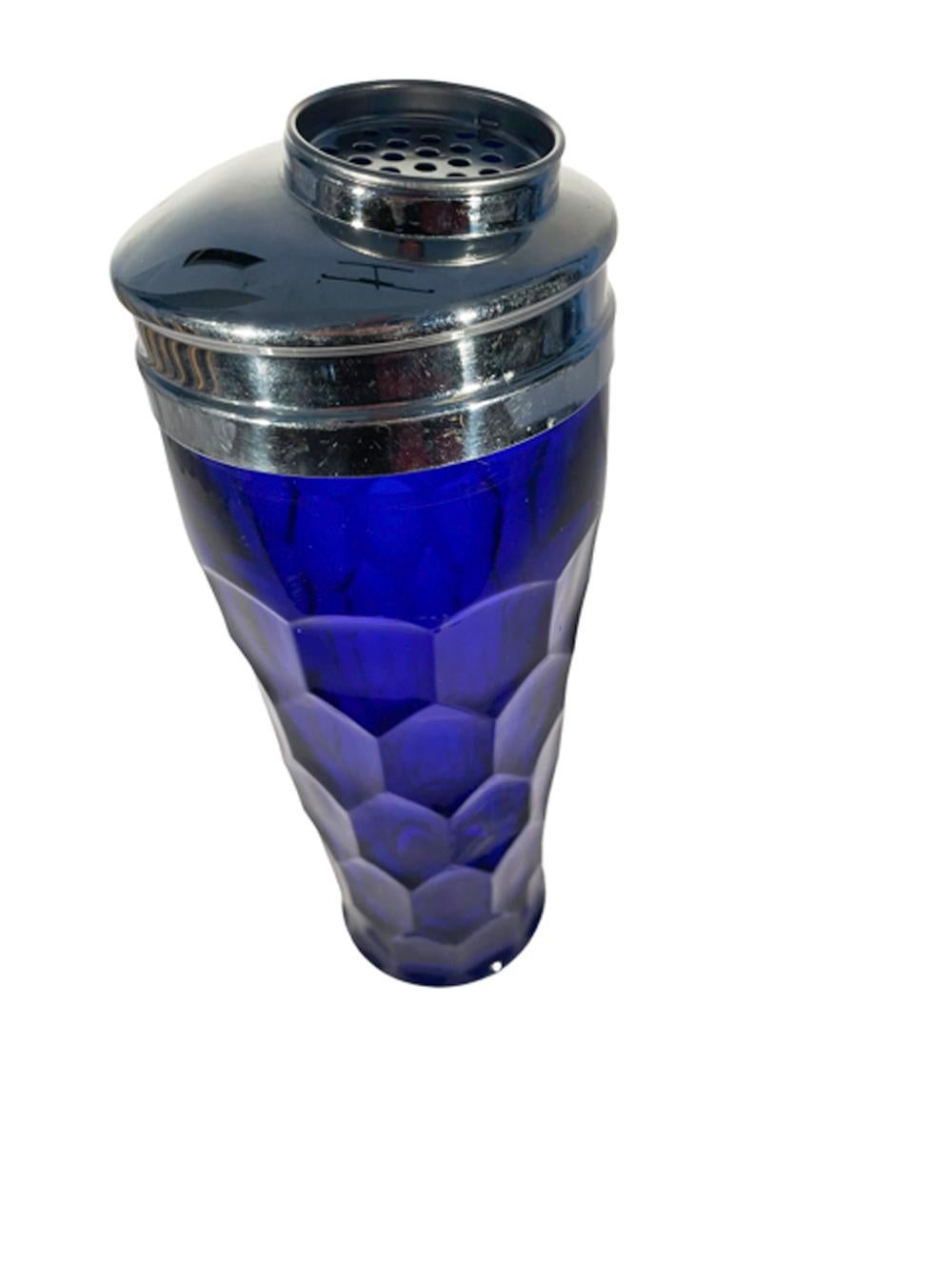Art Deco cobalt blue glass molded with a honeycomb pattern and flared foot and having a chrome lid with large off center pour spout with removable strainer.