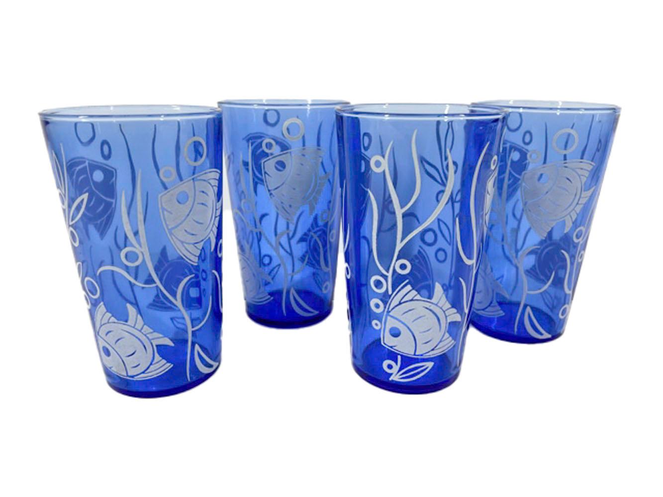 Art Deco, chrome lidded cobalt blue, cocktail shaker and four cocktail glasses with white tropical fish, bubbles and seaweed.