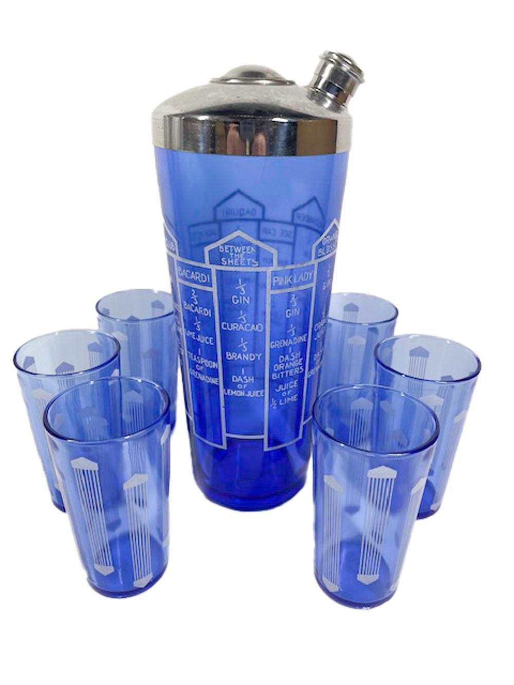 Shaker Art Déco et six verres en verre cobalt avec des graphiques blancs. Le shaker avec un couvercle chromé et 10 recettes de cocktail accompagné de six verres à cocktail avec des groupes de lignes verticales se terminant en haut et en bas par des