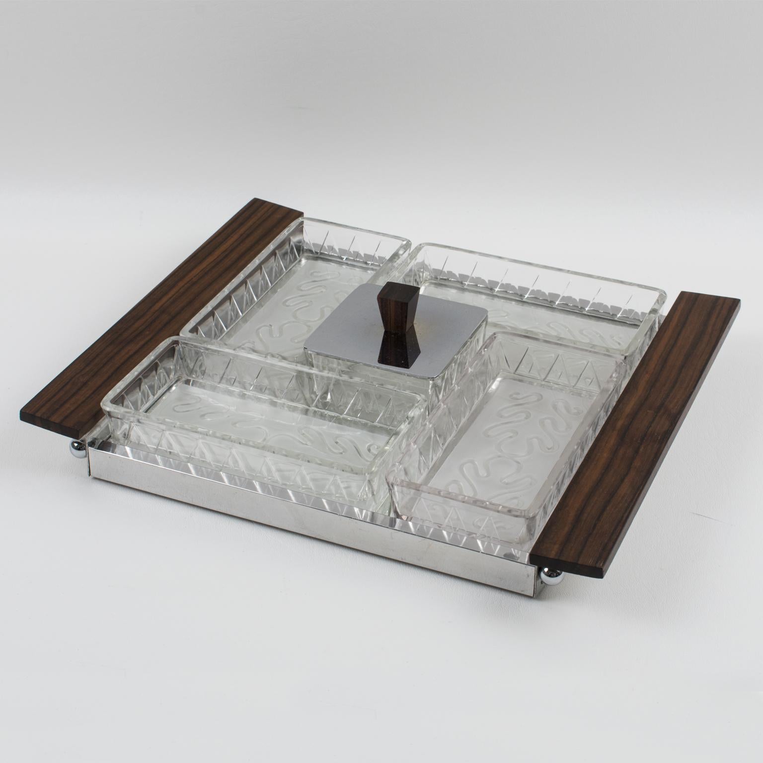 Se trata de un elegante accesorio de bar Art Decó francés para servir entremeses, cócteles, aperitivos o tentempiés. El diseño cuadrado presenta una bandeja de servir de cristal espejado con una galería cromada y asas de madera de Macassar. Los