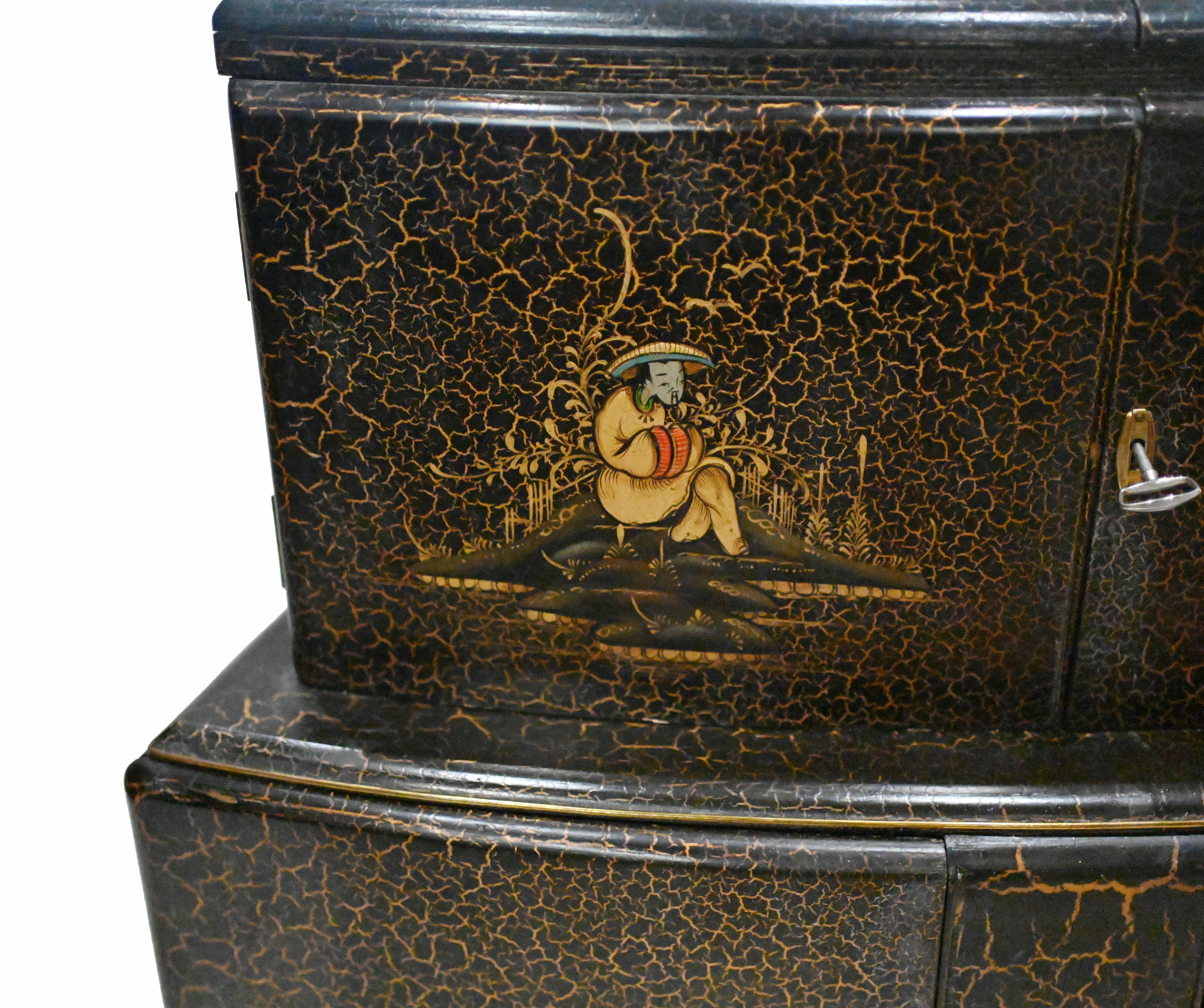 Gorgeous vintage 1930s art deco cocktail cabinet with intricate Chinoiserie
An unusual cocktail cabinet decorated with Chinese figures and Chinoiserie with a black craquelure finish.
Painted designs to the front include Chinese flowers, a wise man