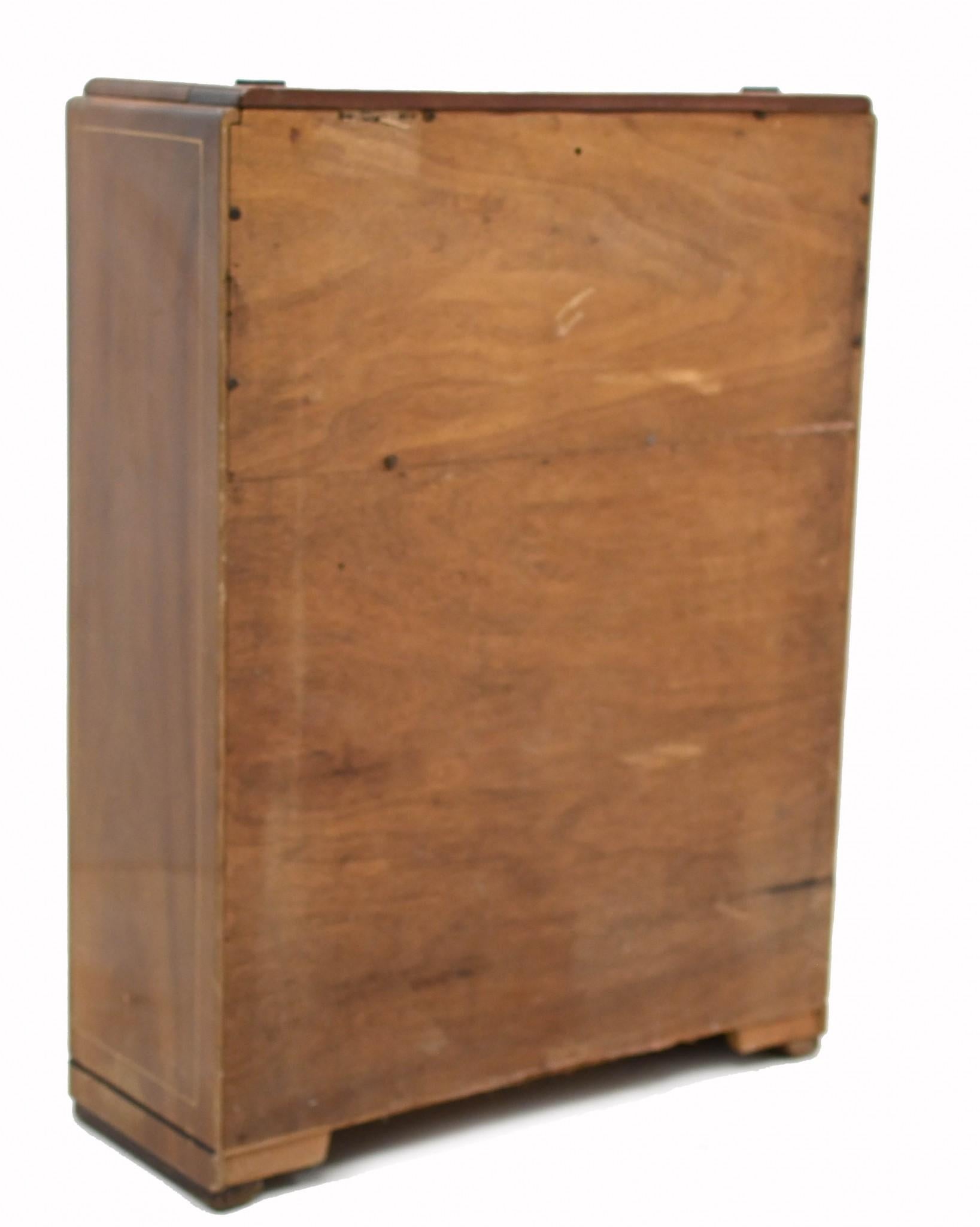 Elegant art deco cocktail cabinet decorate with intricate Chinoiserie
Classic Roaring Twenties piece we date to circa 1920
Opens out to reveal mirrored serving area that slides out
Chinoiserie designs include Asian figures, pagodas and other motifs