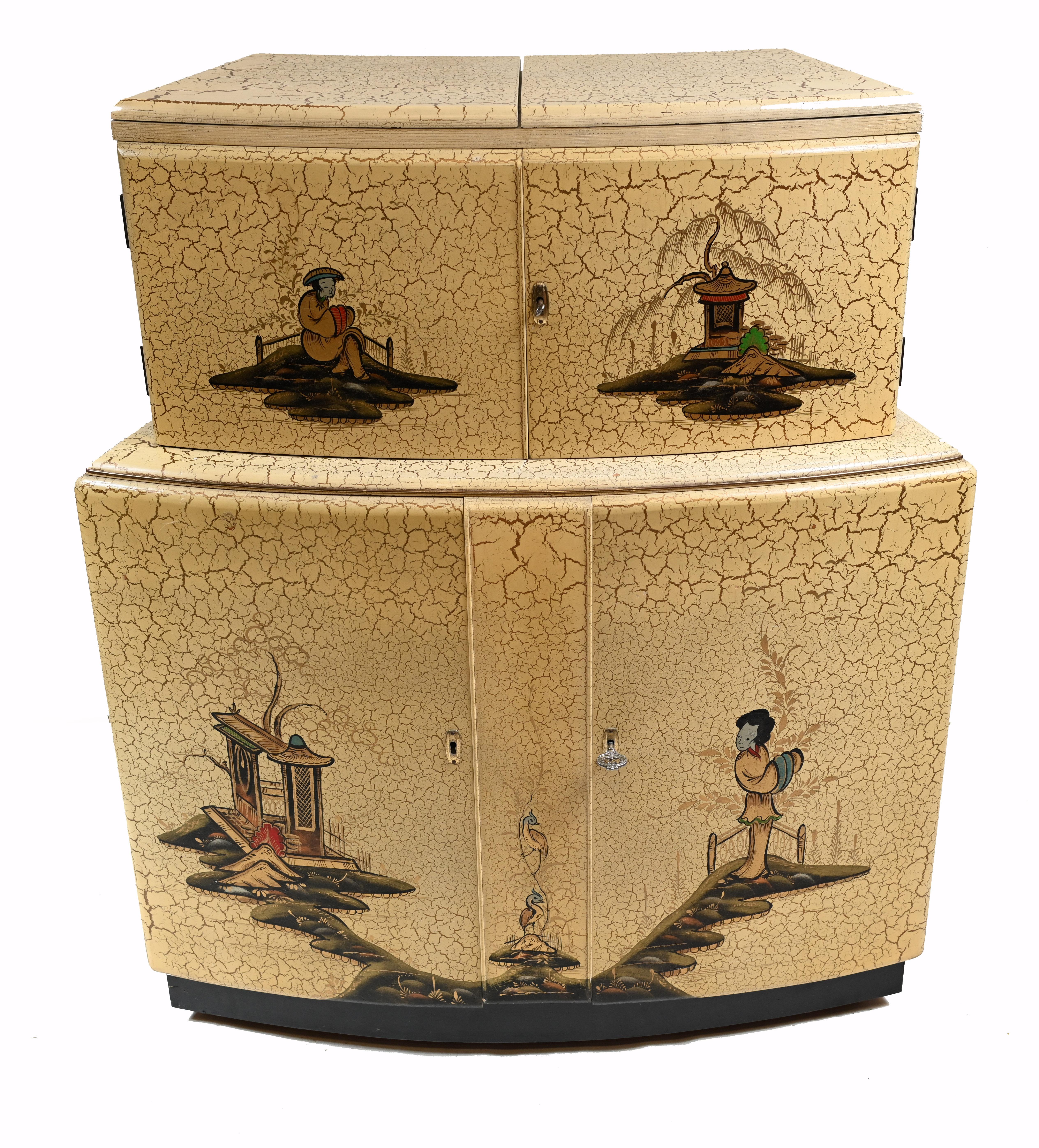 Gorgeous vintage 1930s Art Deco cocktail cabinet
An unusual cocktail cabinet decorated with Chinese figures and Chinoiserie with an off-white crackle finish.
Such a good look to this piece which opens out to reveal a wide bar area - perfect for a