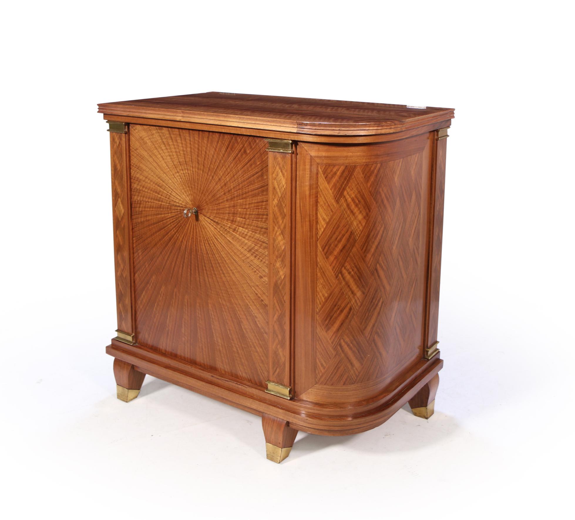 An exceptionally good quality French art deco cocktail cabinet, solid walnut and in parquetry walnut veneer, segmented spiral to the front with column parquetry uprights having gilt bronze fittings to either end. The lift up lid is supported when