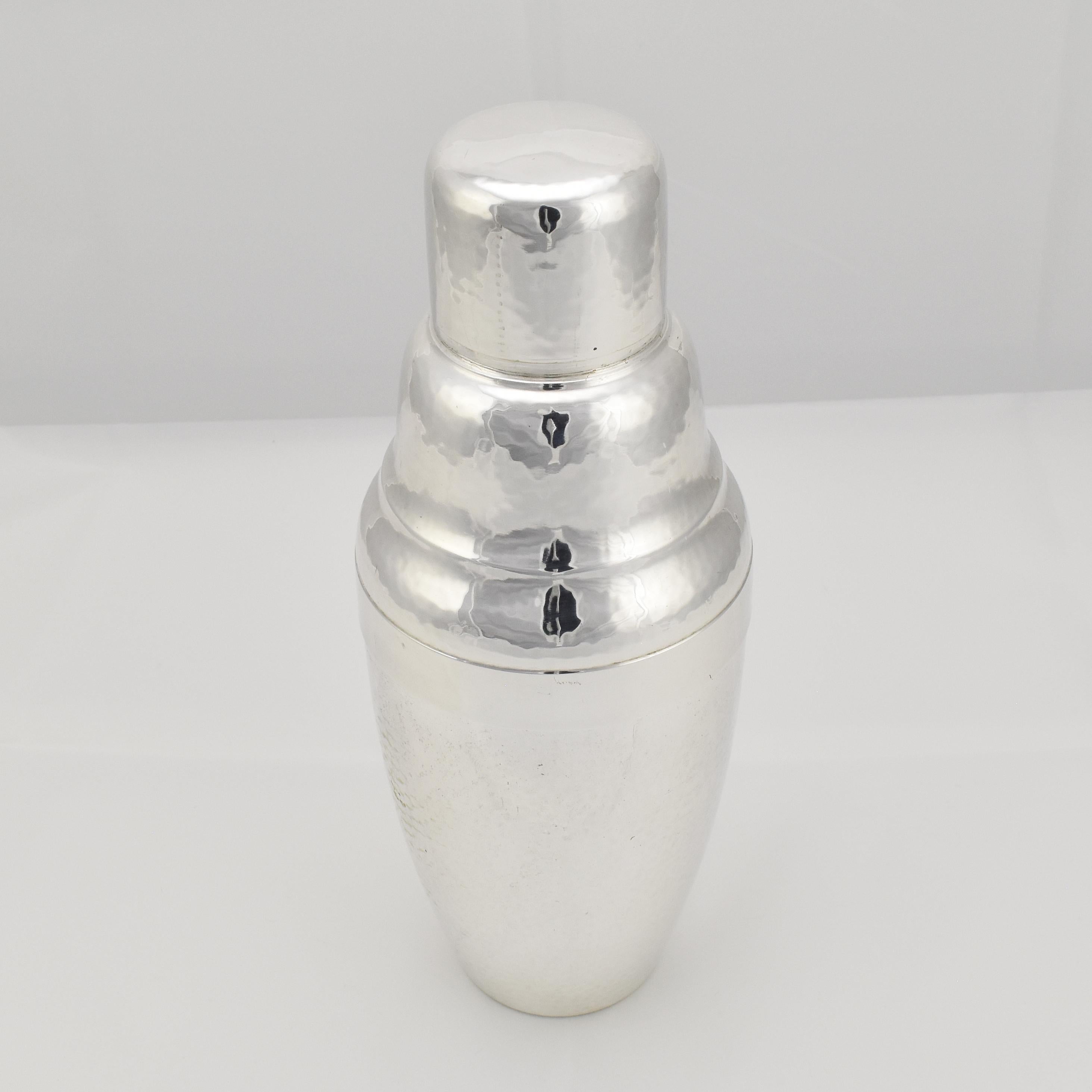 Vintage cocktail shaker with a completely handhammered surface, crafted from silverplated brass by unknown manufacturer OKE

The shape features clean lines, a curvaceous body, and a well-proportioned silhouette.

Imagine this cocktail shaker being