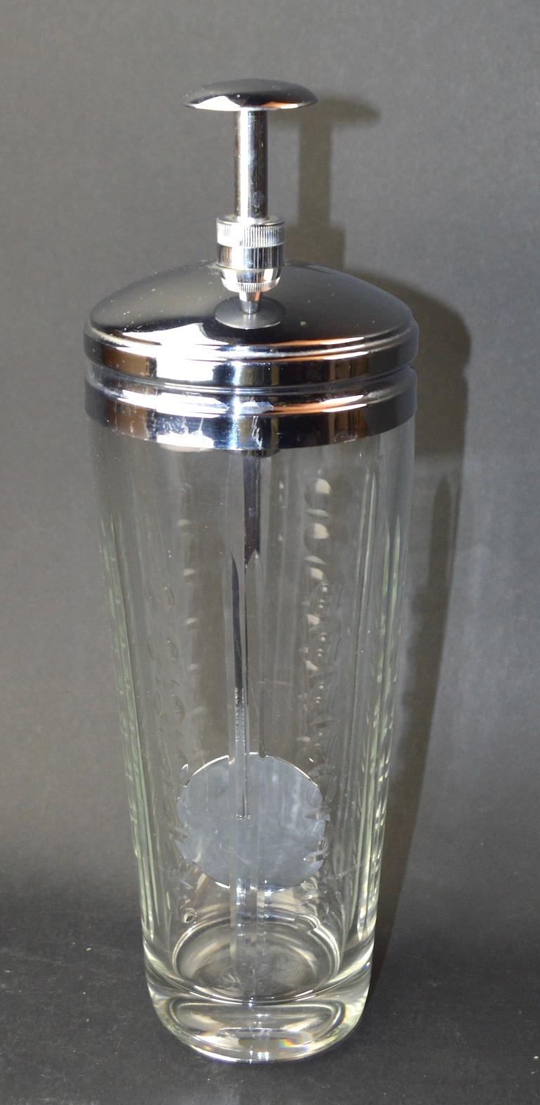 Etched and pressed glass body with bright chrome CAP and mechanical twist mixer element. Push the top knob down and the chrome paddle will spin, making the perfect mixed drink every time. Great novelty item form the Machine Age period, bears pat.