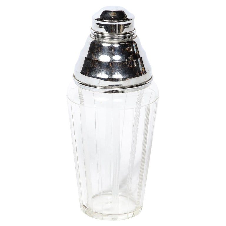 https://a.1stdibscdn.com/art-deco-cocktail-shaker-in-chrome-glass-with-vertically-etched-detailing-for-sale/f_7934/f_353989521690314737015/f_35398952_1690314737431_bg_processed.jpg?width=768