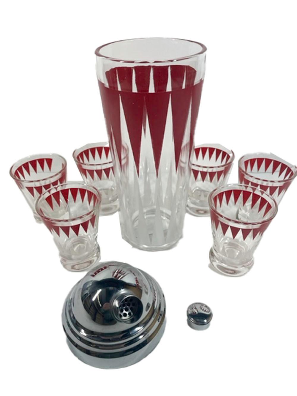Vintage cocktail shaker and 6 footed glasses decorated with white elongated arrows pointing up from the base and red arrows pointed down from the top, the shaker with a chromed lid.