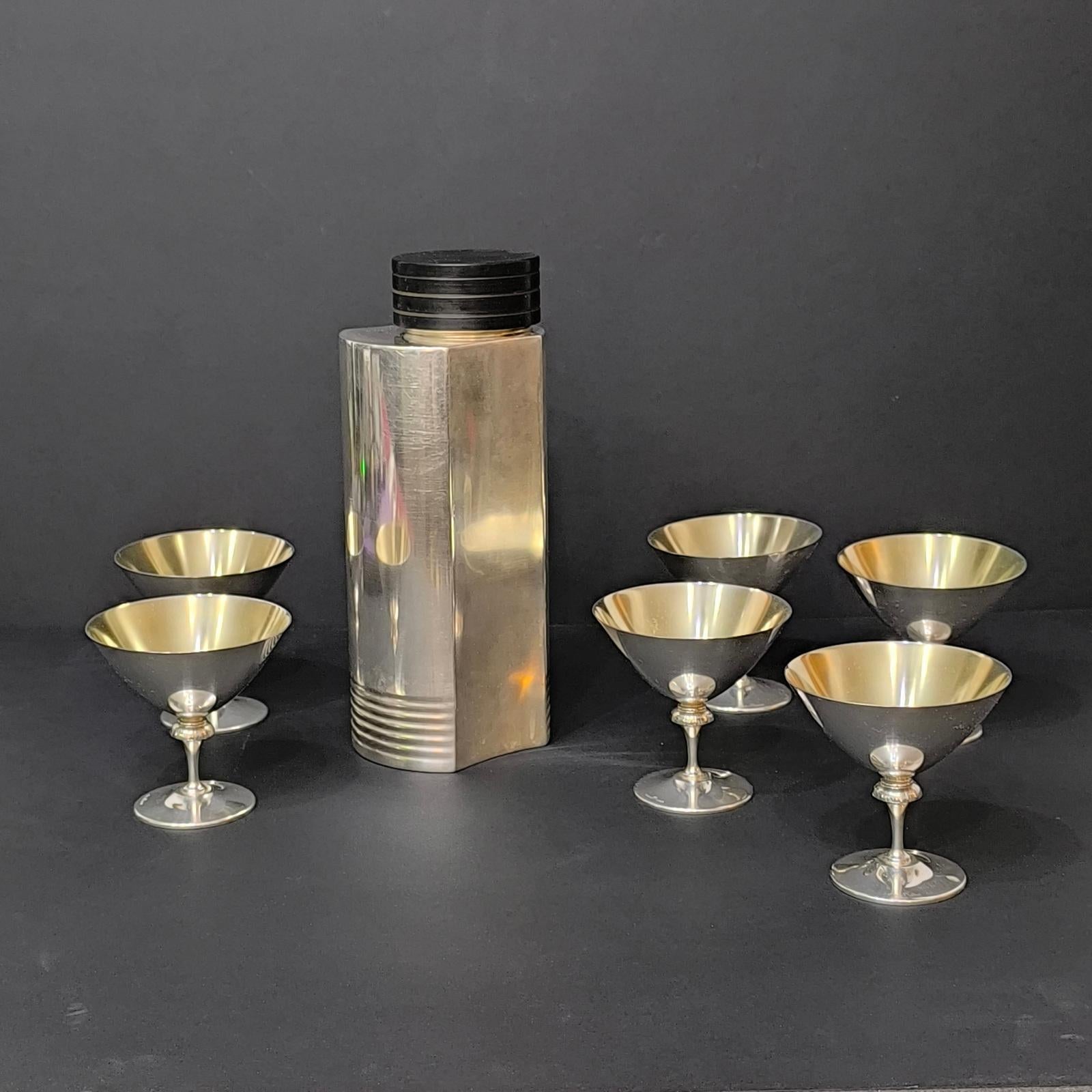 Fabulous, silver-plated Art Deco cocktail shaker and six martini glasses. Designed by Folke Arström in Sweden in 1936 and produced for GAB, each piece is stamped. The shaker still retains the original manufacturer label on the bottom. These items