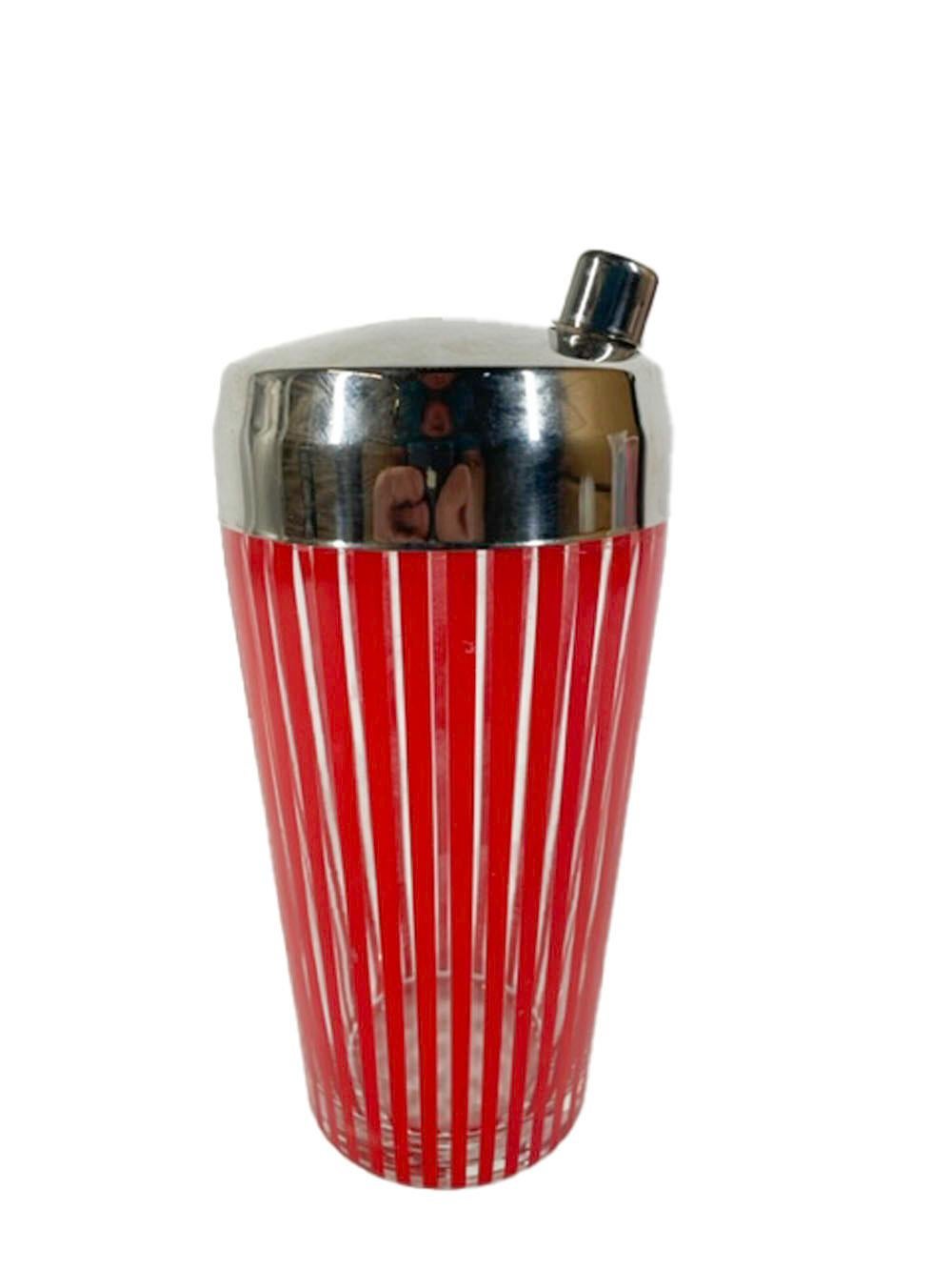 Vintage cocktail shaker of clear glass with a chrome lid and decorated with bright red enamel vertical lines. The chrome lid with an off-center spout and integral strainer.