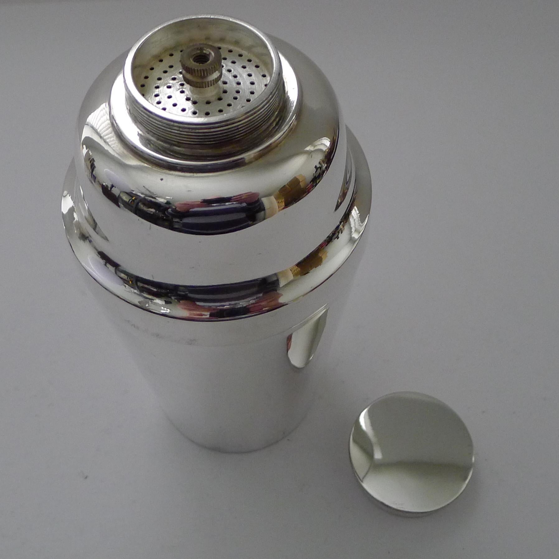 This is a lovely example of an English silver plated cocktail shaker, slightly more unusual in shape with the flattened screw-top rather than the usual pull-off cap.

Another unusual feature is the little instrument inside the lid leading to a