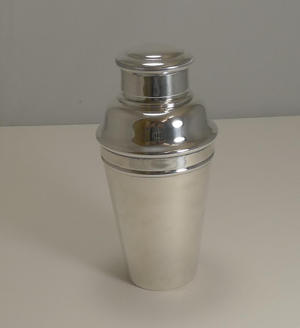 A handsome Art Deco one pint Cocktail Shaker in silverplate. Highly desirable, this one has an integral ice crusher which is revealed once the upper portion is removed.

The underside is signed by the silversmith, William Sturtcliffe & Sons and is