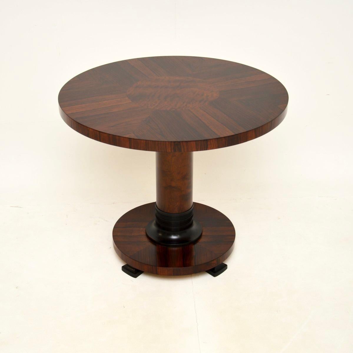 A stunning Art Deco coffee / occasional table, made in England and dating from the 1930’s.

It is of superb quality with a stylish and bold design. The circular top has a thick edge, segmented with a satinwood centre. It stands on a thick column