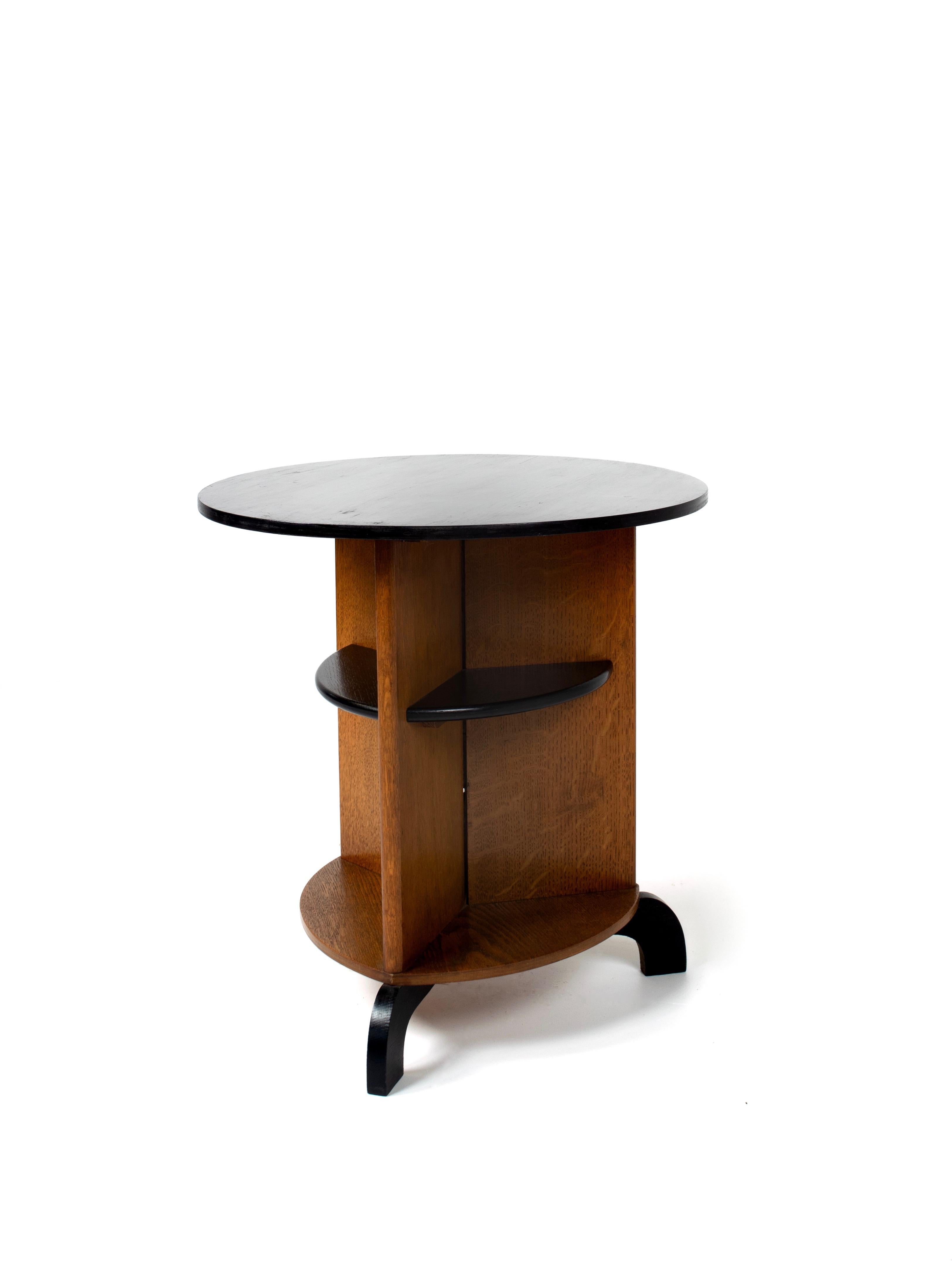 Beautiful Dutch Art Deco from The Hague, The Hague School, side, or coffee table. The design is sober, but friendly with the round forms and three legs under it. It is 57 cm high and has a diameter of 54 cm. It a combination of oak with black