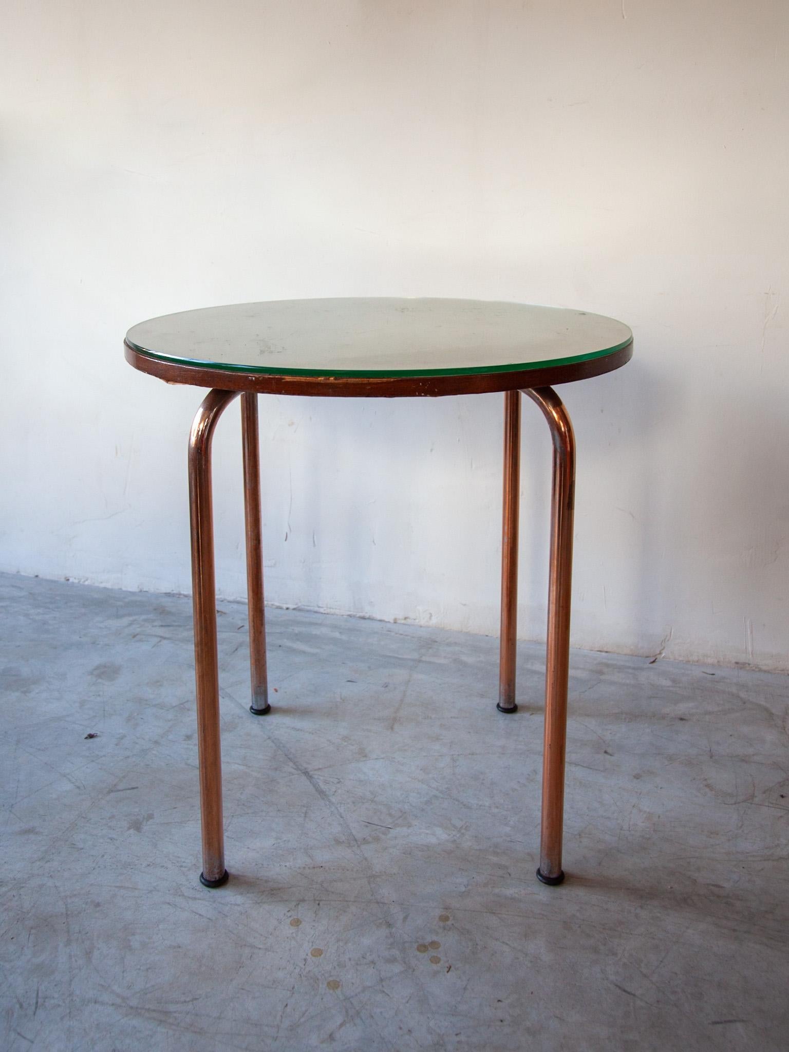 This coffee, side table was designed by Thonet in the 1930s. The table features a tubular brass metal base and a Beechwood top with round faceted glass. In good Vintage condition. Dimensions: Height: 70 cm, Diameter: 60 cm.