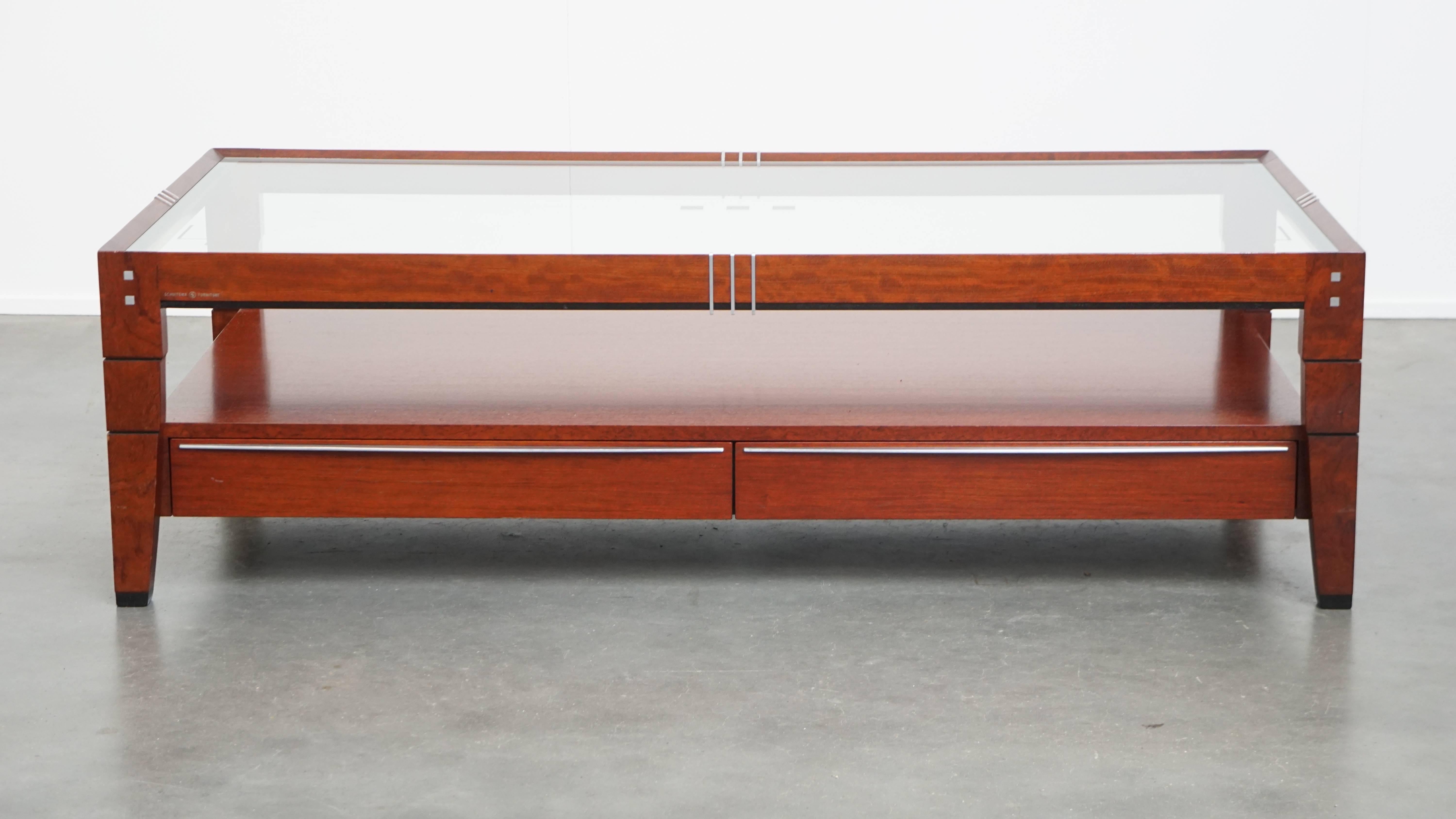 Offered here is this stunning Art Deco coffee table by Schuitema from the Decoforma series, featuring a glass top and four drawers. 

This exceptional piece is made by the renowned Dutch brand Schuitema and showcases the beautiful and distinctive