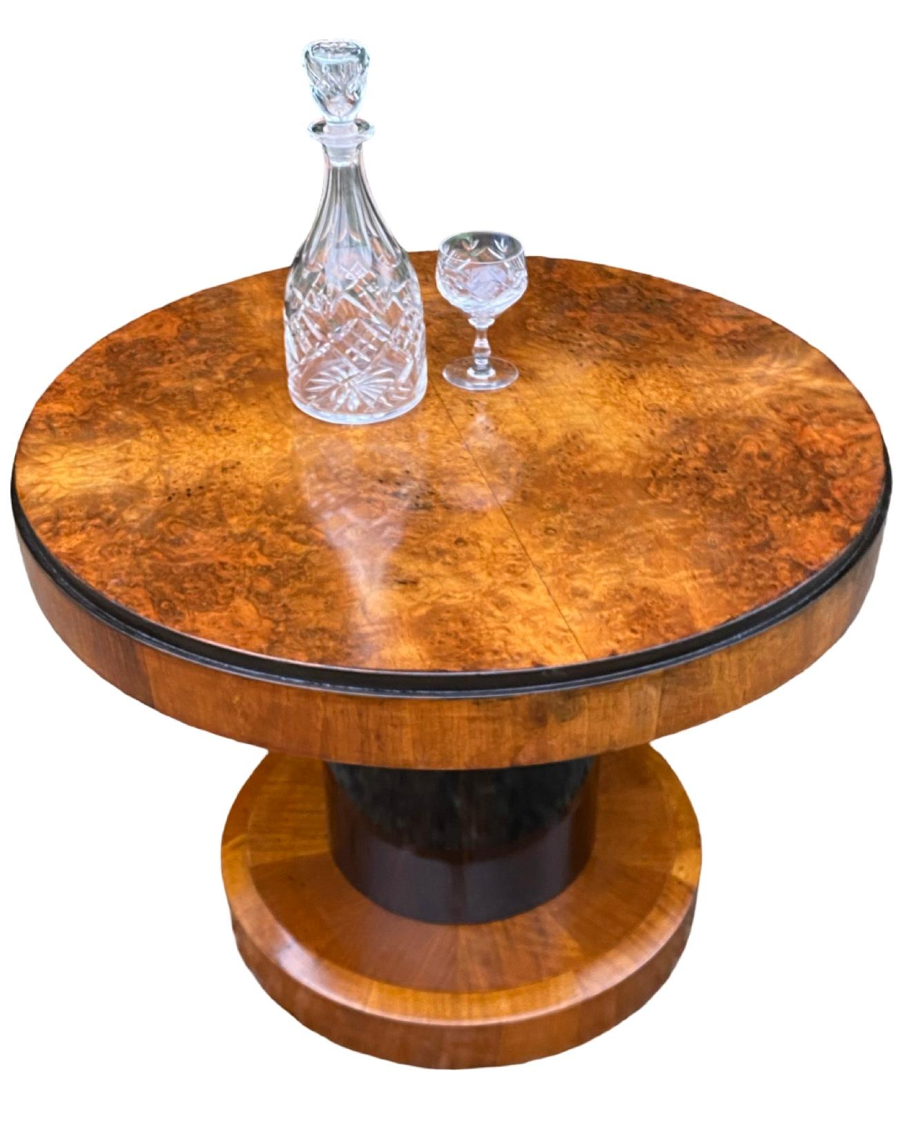 A gorgeous Art Deco Coffee Table dating to Circa 1930. The top is highly figured walnut and a lovely rich conker colour with ebonised surround. . The stem is faux maccassar which adds a dramatic feature to this already attractive table. Raised on a