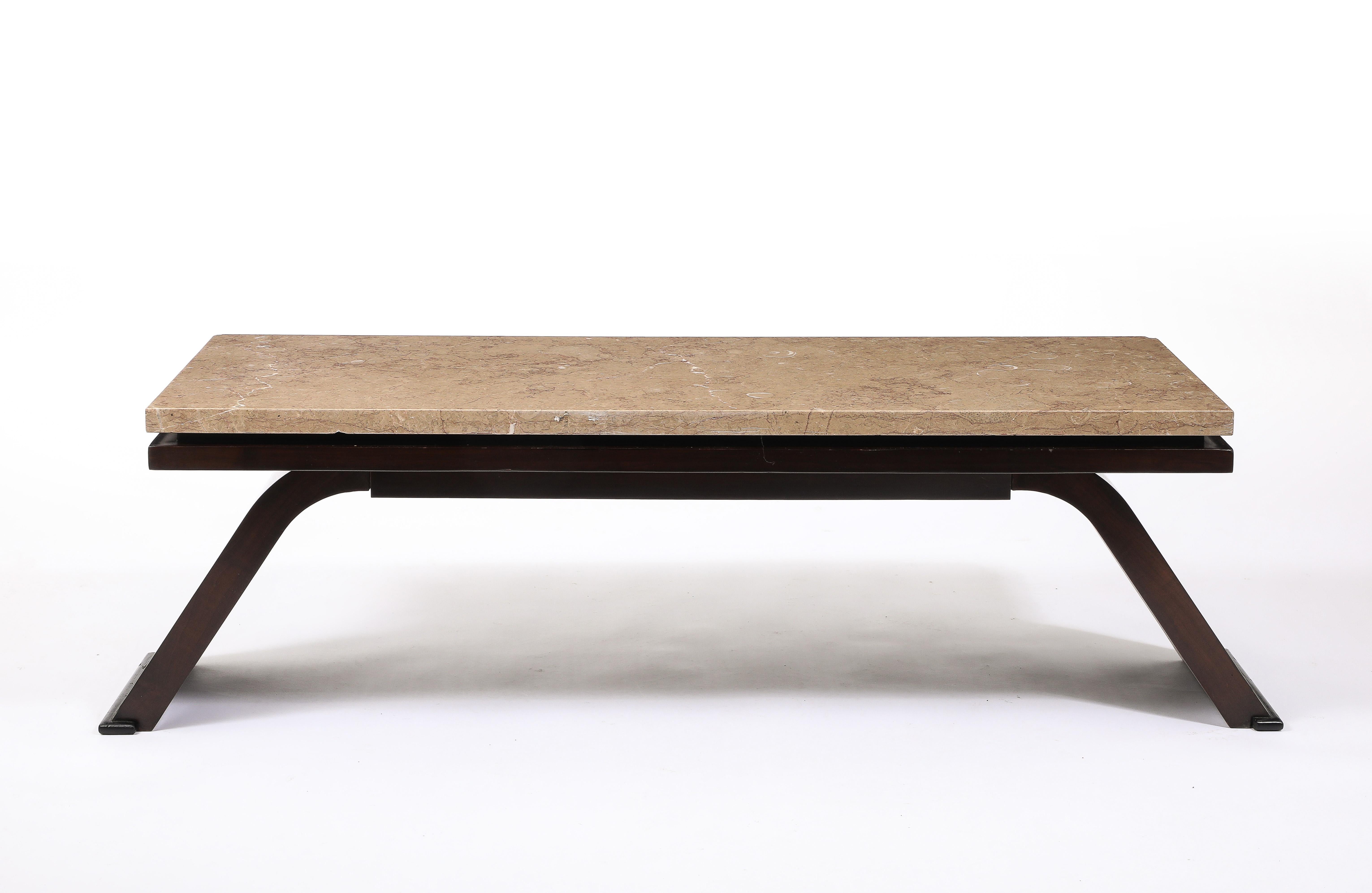 Long coffee table in the Manner of Dominique with an offset beige marble top.