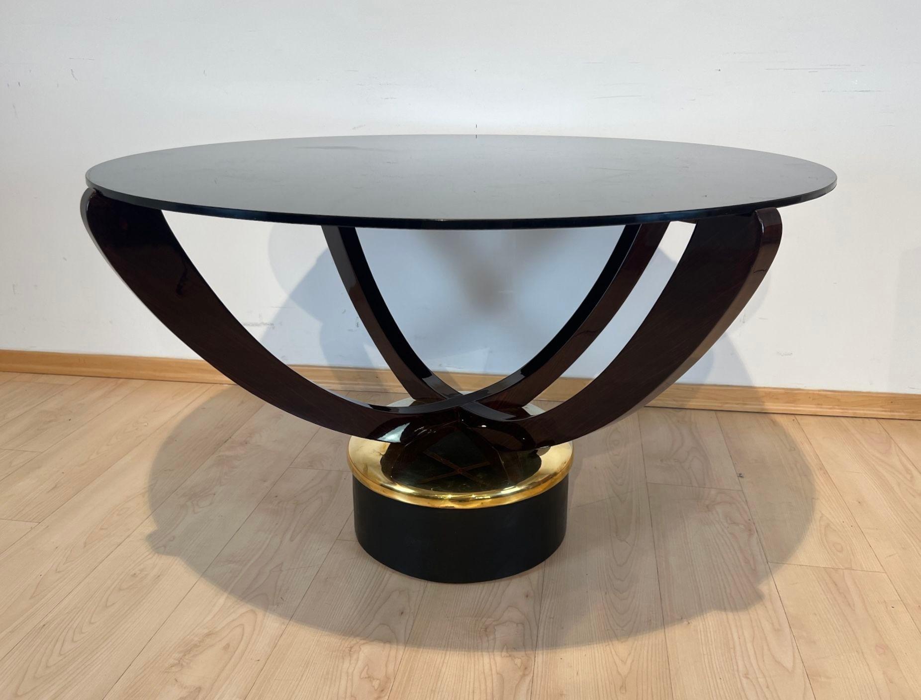 Large round Art Deco coffee table from France around 1930.
Four legged Rosewood frame, lacquered. Polished metal base with protective varnish, covered with blackened leather.
Large original glass top with scratches (could be replaced if