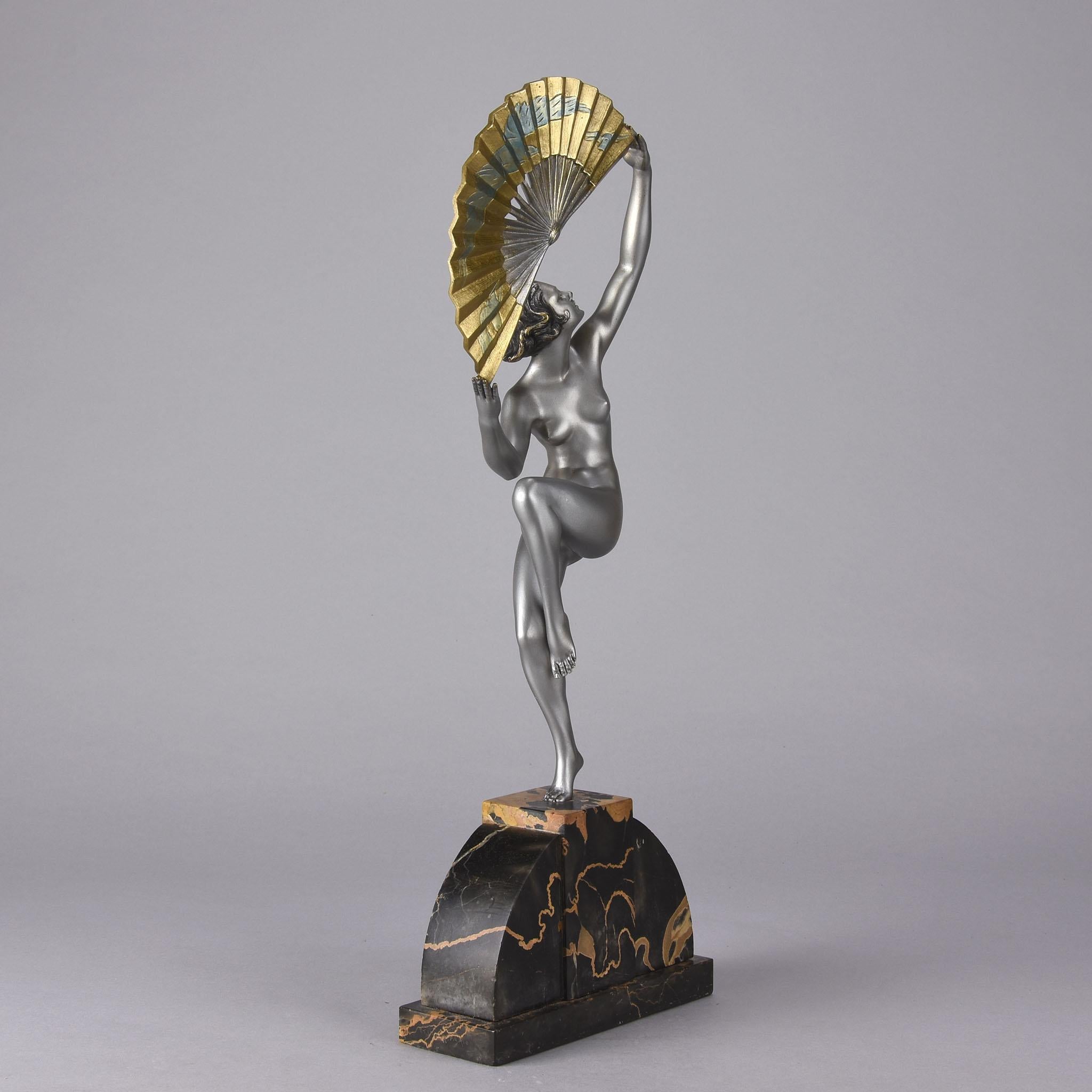 Impressive early 20th century Art Deco cold painted silver enamel bronze figure of a beautiful naked woman in a striking pose, holding an open fan that is intricately decorated above her head, raised on a shaped base, signed Bouraine and with Etling