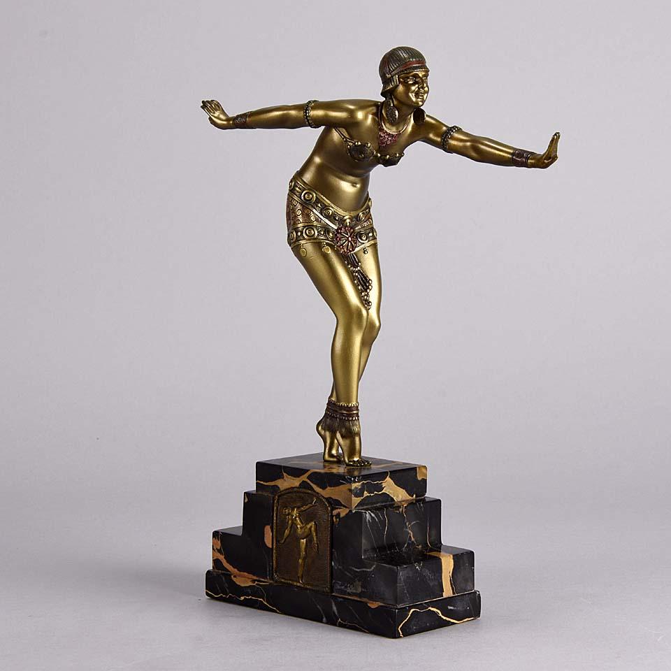 A fabulous cold painted Art Deco bronze figure of a Ballet Russes dancer in full costume holding a striking pose with excellent enamel painted color and fine hand finished detail. Raised on a portoro marble base, signed D H Chiparus and inscribed