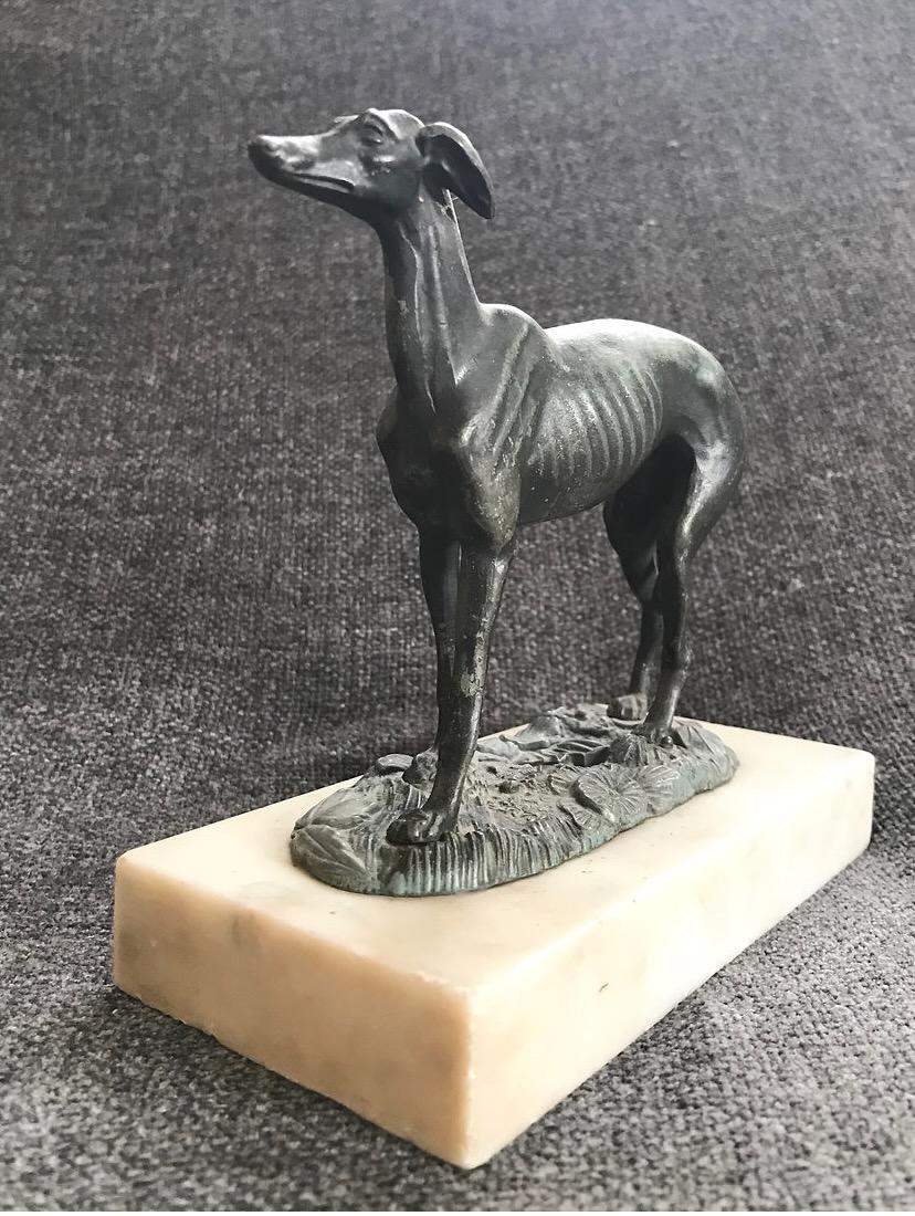 Circa 1925, an absolutely charming cold painted Spelter figure of a standing greyhound. This elegant lady captured standing head alert, looking forward, beautifully depicted with the long muscular legs, slimline waist with ribs showing, long tail