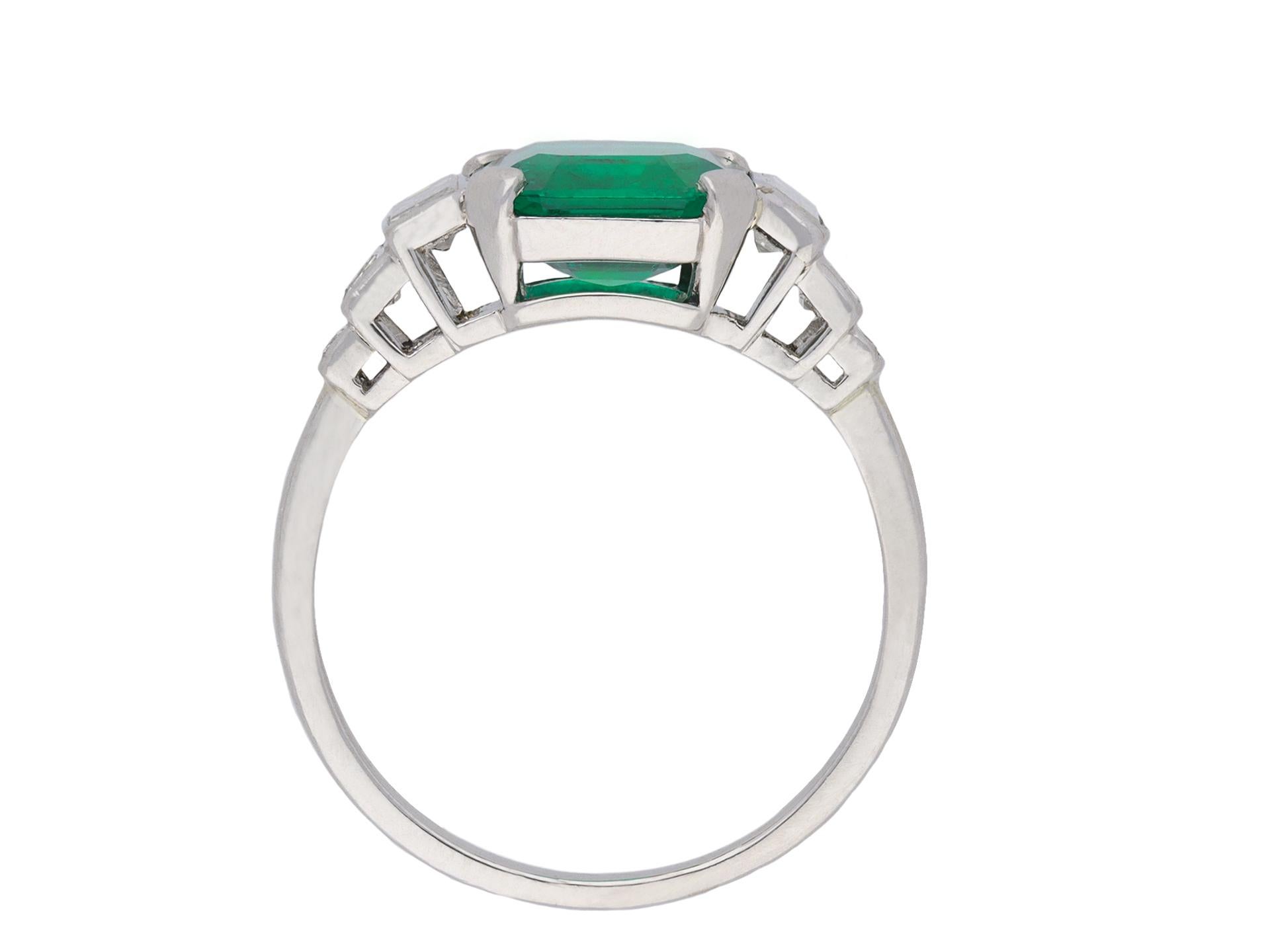 Octagon Cut Art Deco Colombian emerald and diamond flanked solitaire ring, circa 1925. For Sale